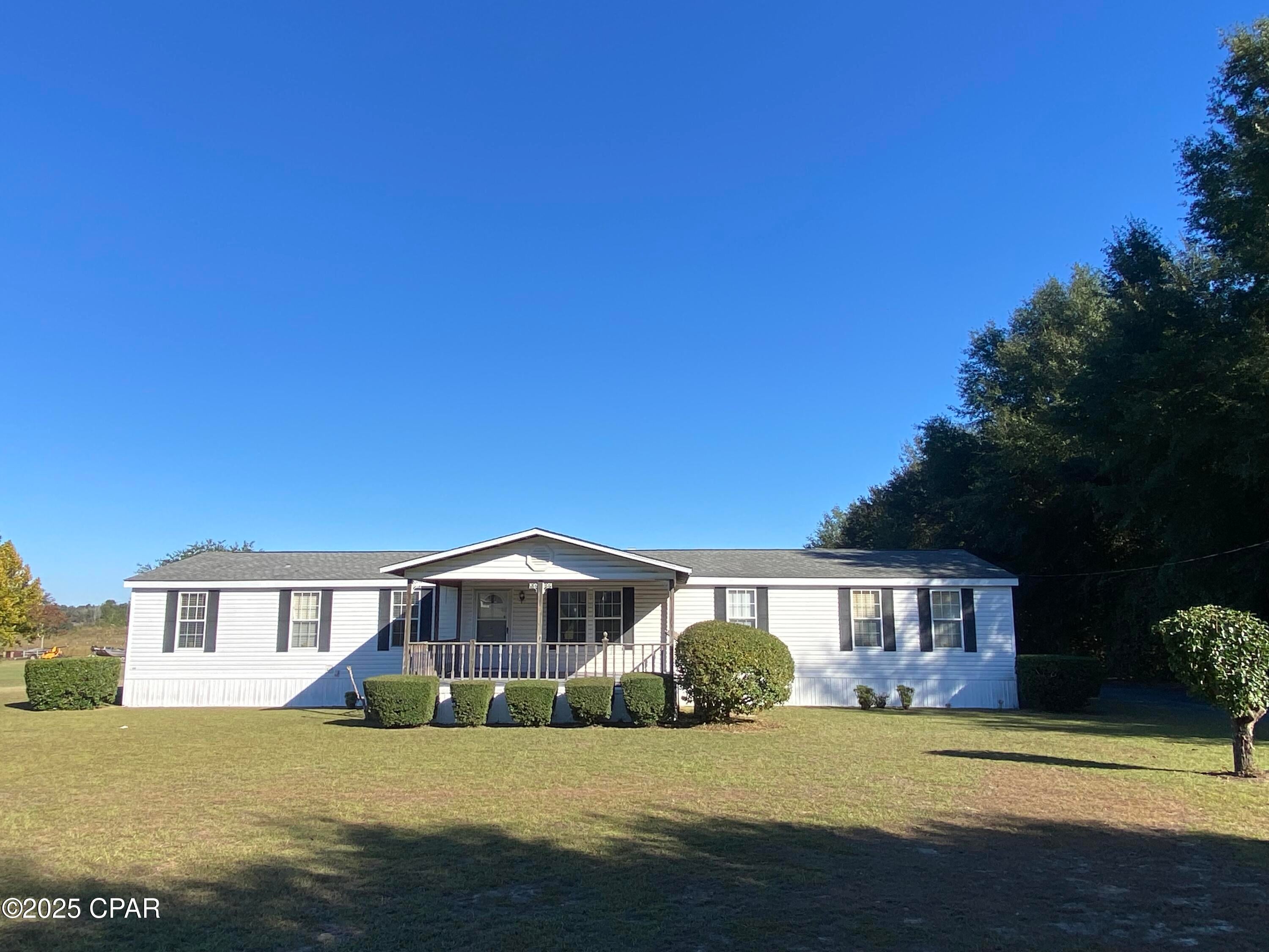 Check out this 4 bedroom, 2 bath mobile home offering 2,128 square feet of living space on 1.21 acres. Step through the front door into a spacious living room, with an additional den featuring a wood-burning fireplace. The kitchen provides plenty of cabinet and counter space, along with an island that offers seating for bar stools. The dining area and kitchen have windows overlooking the backyard.
The master suite includes a sitting room, a large master bath with double vanity, soaking tub, and separate shower, as well as a generous walk-in closet complete with built-in drawers and shelving. With a split-bedroom floor plan, this home provides ample space for the entire family to spread out.
Enjoy beautiful sunsets from the 16' x 20' covered front porch (some of the deck boards need to be replaced). There's a huge 12' x 40' storage building/workshop with electricity (some interior boards need to be replaced). The back yard has a beautiful country view and there's plenty of space for your pets and kids to play.  Come enjoy our peaceful, country lifestyle!
