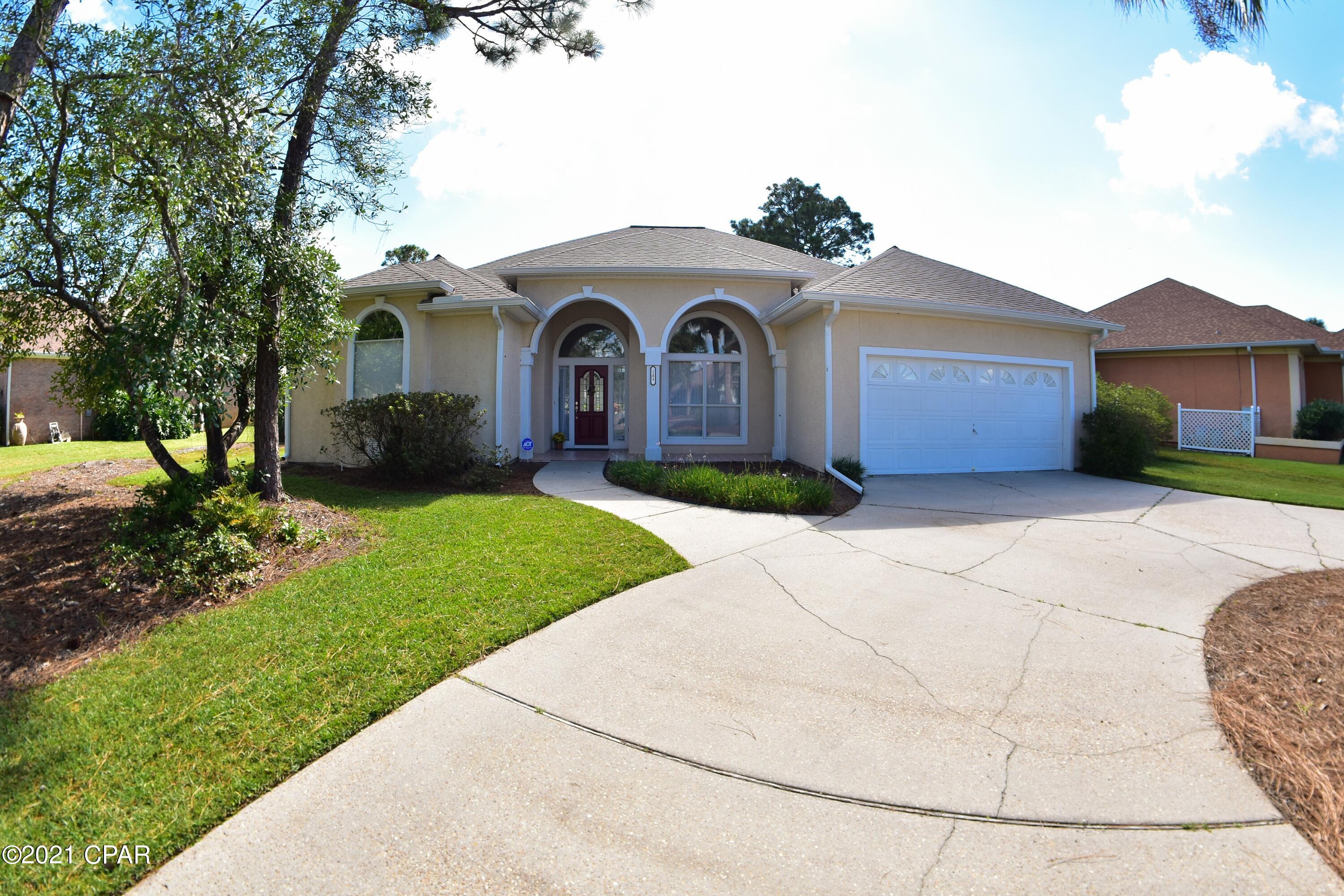 CURRENTLY UNDER CONTRACT, SELLER ACCEPTING BACKUP OFFERS.  You'll love this beautiful lakefront home in The Glades!  This single story 3BR/2.5BA home boasts a screen-enclosed pool, a circular driveway & a two car garage. The interior features a split-bedroom floor plan with formal living & dining rooms, a large kitchen with Cambrian Quartz countertops & a substantial pantry, a family room with fireplace, & tons of natural light thanks to rectangular & arched transom windows throughout the home.   Let's not forget the view of the pool & lake from most of the rooms!  The Master Suite has private access to the patio & pool area & the en suite includes double vanities, separate shower, whirlpool tub, & his-and-hers walk-in closets.  The home was pressure washed, it's all electric, and t The lake has been enlarged and dredged to prevent high water issues.  The Glades subdivision is centrally located in PCB and within minutes of dining, shopping, entertainment, and the gorgeous white sandy beaches on the Gulf of Mexico!  All info is approx and must be verified by Buyers if important.