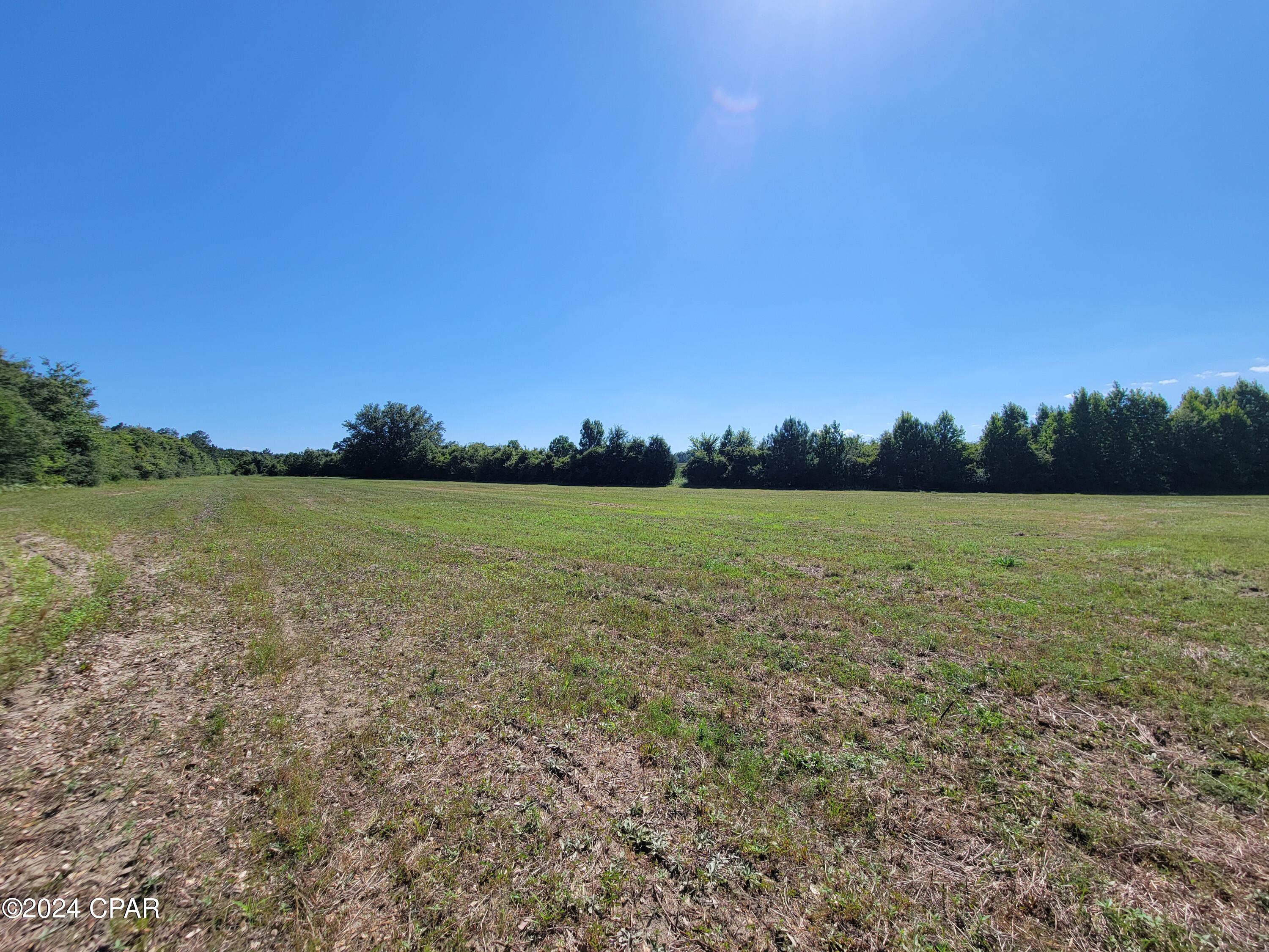 Welcome to this beautiful 14+/- acre parcel located in the peaceful countryside of the Florida Panhandle! With highway frontage and easy accessibility, this property offers a great opportunity to build your dream home, create a private country retreat, or invest in a piece of Northwest Florida land. With plenty of room to spread out, no HOA, and super-low property taxes, you can enjoy the freedom and affordability of country living.

Location is another great feature! The property is approximately an hour's drive from the world-famous white-sand beaches and emerald waters of Panama City Beach, with the beautiful beaches and communities of Destin and 30A also within easy reach. Vortex Spring is only about 10 minutes away and is known for its crystal-clear, spring-fed waters, swimming, snorkeling, scuba diving, and outdoor recreation.

Don't miss your opportunity to own this gorgeous piece of the Florida Panhandle and turn your dreams into reality. Additional acreage is also available!