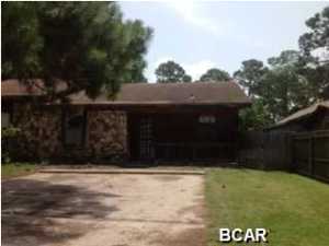 Here's your opportunity to own a unit in Panama City Beach, at an affordable price. This unit is one-half of a duplex, with no HOA fees. The exterior is low-maintenance cedar siding with lovely stone accents. The back yard is fenced and has a storage shed. Enjoy afternoons on the screened porch, after a day at the beach, which is only a 6 minute drive. (All info is approximate and Buyer must verify ANY info that is important.)