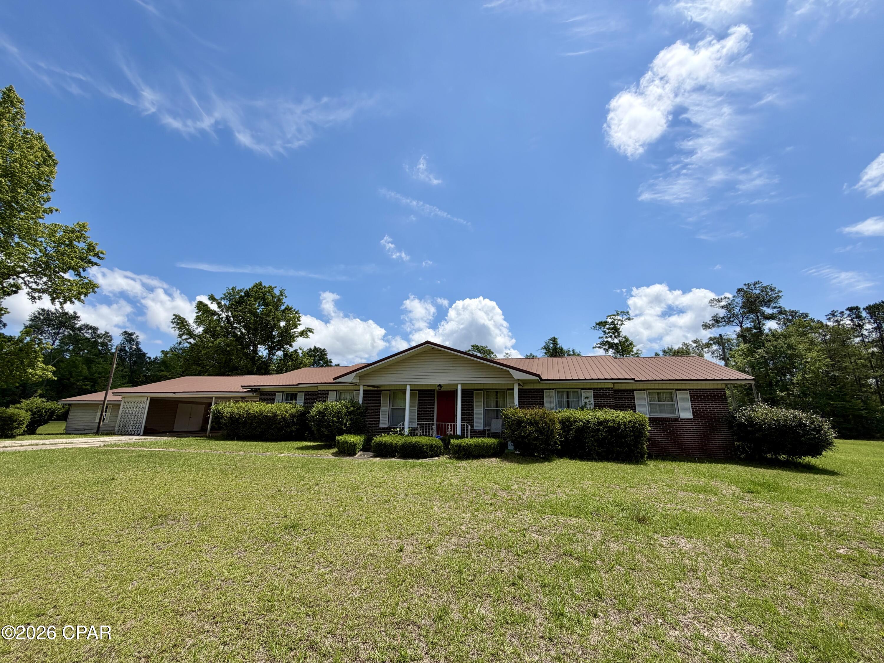 If you've been looking for a large home for your family, this is it!!  Check out this 4 bedroom, 3 bath brick home with 2,546 heated & cooled square feet situated on 2.62 acres! Features include a formal living room and dining room, den with built-in entertainment center and an additional room off the den with a freestanding wood-burning fireplace. The master suite offers a built-in desk, built-in chest of drawers, his and hers closets and a step-in shower in the master bath. Two of the additional bedrooms feature built-in desks, cabinetry and shelving. Outdoor amenities include a covered patio, huge storage room, pole barn, pump house with storage and dog pen. Updates include a water filtration system, roof replaced in 2019, water heaters replaced in 2022 and HVAC replaced in 2024.