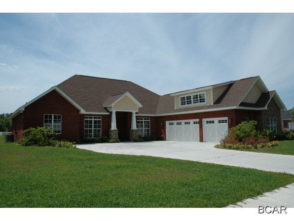 From one of Bay County's premier builders, this Coastal Craftsman four bedroom home awaits you and your family. Located in College Point, this home has almost 3500 square feet of living space with a four bedroom/three bath split floorplan. As you walk in the 8-foot mahogany front door, you will immediately notice the natural light flooding the home. The hardwood floors in the foyer and dining room are oak. There are two living areas and the family room with fireplace is open to the kitchen - great for entertaining. The kitchen features custom stained hickory cabinets, Southern Marble acrylic counters, a breakfast bar and stainless appliances. The spacious master bedroom overlooks the picturesque pond in the center of the neighborhood. There are walk-in closets leading to the large master bath. The tiled master bath has double vanities, a separate shower and whirlpool tub. Upstairs there is a large bonus room - perfect for an office or media room. The three-car side entry garage is quite large and has an additional storage area as well. Make an appointment to see this beautiful home today.