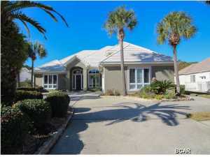 Custom built Bay Point canal home offering 4Br/3.5ba and 90 ft on the water. Enter this elegant custom home through a beautiful bevel leaded front door. Its 14 foot ceilings in the foyer, living room and dining room welcome you to a spacious area with deep crown molding, gas fireplace, wet bar and TV/music entertainment area. The openness of this floor plan flows well throughout and lends itself to entertaining. The beautiful granite counter tops are a great accent against the 3 walls of cabinets and open shelving. The huge island boasts its work space, additional large sink with garbage disposal and cooktop and still allows room for informal dining or a spread of hors d'oeuvres. The massive round table for ten in the breakfast area overlooks the pool and patio completing this