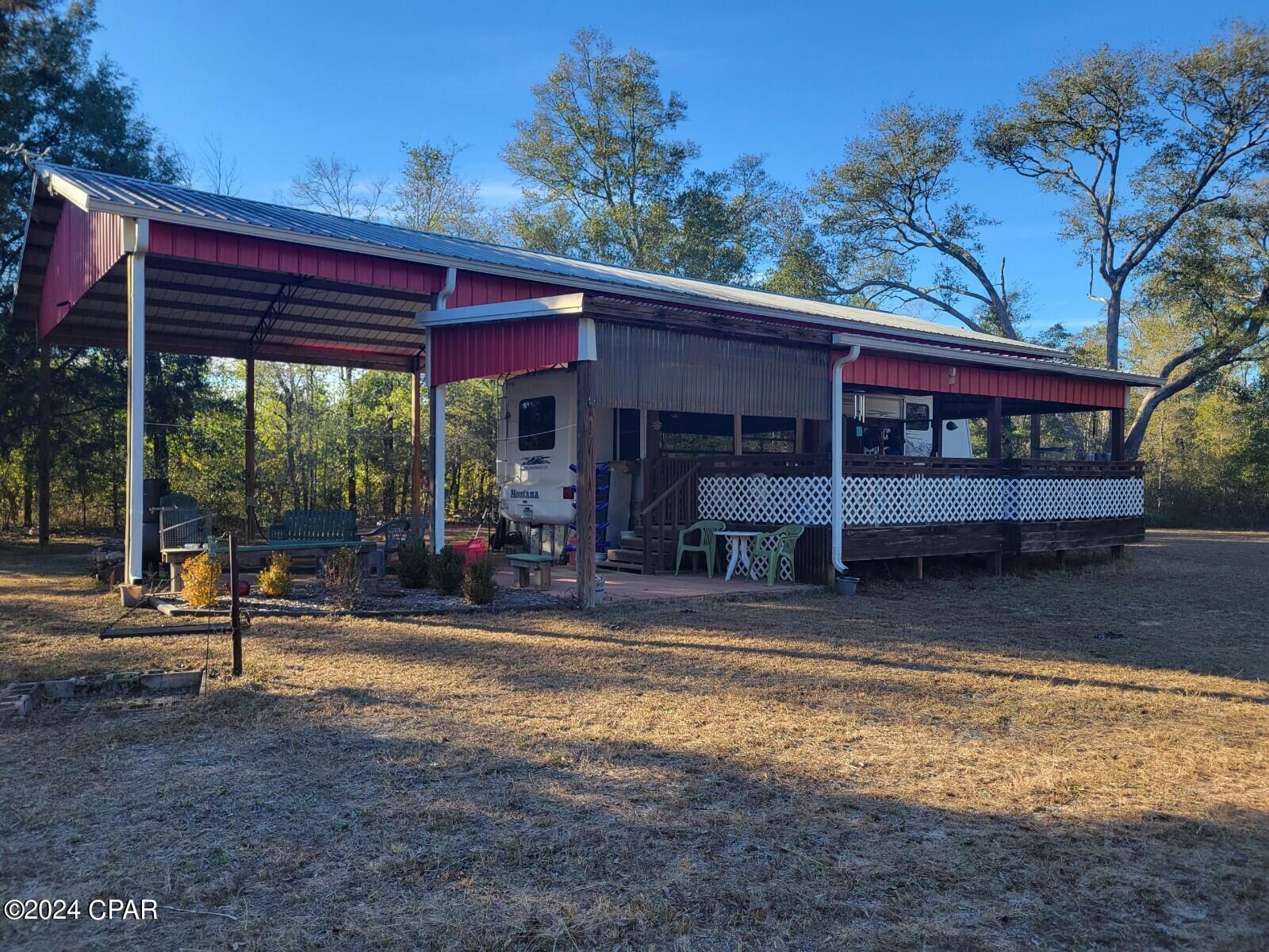 Tranquity at its best. This property has potential for whatever your heart desires , build a home , use as a weekend getaway, and great for hunting ducks or deer. Has a 30 x 60 Pole Barn with a travel RV 
 ( that will remain with the property) Covered 14x24 Deck and a patio 12x12.. NO  expense for putting in utilities,there  is electric, septic, and well. Also a 250 gallon propane gas tank.  If you are looking for a for vacant land to use as getawy, look no further THIS IS THE PLACE