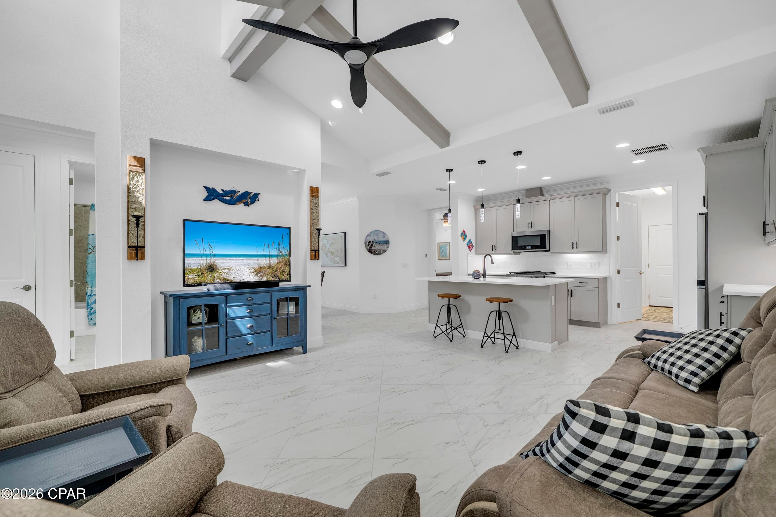 TURNKEY LUXURY AT LATITUDE MARGARITAVILLE! Welcome to 9320 Cool Breeze Dr, a highly upgraded Camellia Cottage conveying fully furnished in the highly sought-after 55+ community of Latitude Margaritaville Watersound. Situated in Phase 6A, this home offers a prime location with its own dedicated gate and no neighborhood cut-through traffic, all while remaining a convenient golf cart ride to Town Square rather than the longer drive from later phases. This turnkey opportunity completely bypasses new construction waitlists, builder timelines, and furniture delivery delays for an immediate move-in ready experience. 

Inside, the open layout is elevated by 8-foot interior doors, upgraded large-format porcelain tile flooring flowing continuously throughout, and ceiling beams that add style to the main gathering area. The kitchen features premium cabinetry accented by upper and under-cabinet ambient lighting, quartz countertops, an undermount sink, gas range, and a custom walk-in pantry with wood shelving. The primary suite serves as a spacious retreat, complete with a custom closet system and an ensuite bath featuring floor-to-ceiling tile in the walk-in shower, a frameless glass enclosure, and a quartz double vanity. 

Outdoor living is easy on the private screened lanai finished with durable epoxy flooring, perfect for morning coffee or relaxing evenings. The attached two-car garage is equally well finished with matching epoxy floors, a utility sink, and an upgraded, low-noise, ''smart'' garage door opener that has a camera and can be opened remotely. Cottage HOA dues provide low-maintenance peace of mind by covering exterior lawn care, scheduled exterior repainting, and roof replacement schedules. 

Located just 7 miles from the white-sand beaches of the Emerald Coast, this community sits directly along the Intracoastal Waterway. Residents enjoy world-class amenities including the resort-style Paradise Pool, the two-story Bar & Chill restaurant, Fins Up! Fitness Center with an indoor lap pool and spa, tennis and pickleball courts, kayak launch, Barkaritaville dog park, Last Mango Theater, and regular live entertainment at the bandshell. With the new Publix town center and healthcare facilities nearby, everything needed for effortless coastal living is right at hand. Pack the bags, bring the golf cart, and welcome to paradise! Schedule your showing today. A video tour is also available