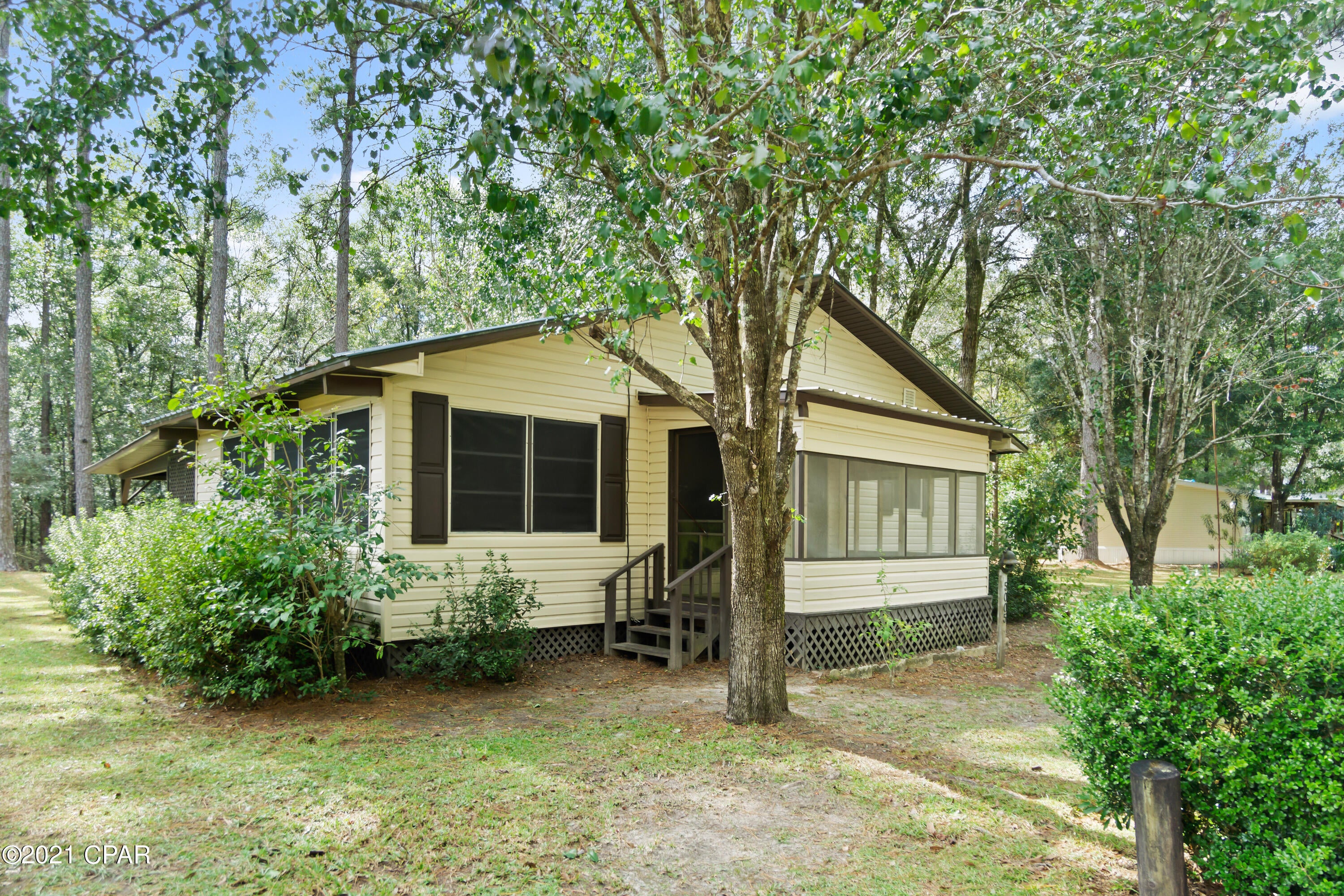 VACATION COTTAGE, AIRBNB or VRBO POSSIBILITY CLOSE TO THE BEACH!!! This cozy cottage is the solution!!!  It is located only 35 miles north of the world's most beautiful beaches, within walking distance to Redbug Lake and the Choctawhatchee River.  Go to the beach, enjoy spectacular fishing or just relax in the swing on the back screened in porch.  This adorable cottage provides all the necessities to get away for a fun filled vacation.  The back of the home has a covered lean-to and there is an enclosed boat/storage shed with a screened in fish cleaning room.  Located next to thousands of acres of water management area, there are plenty of opportunities for hunting as well.  Don't miss this rare opportunity to experience an ideal place for rest and relaxation!!