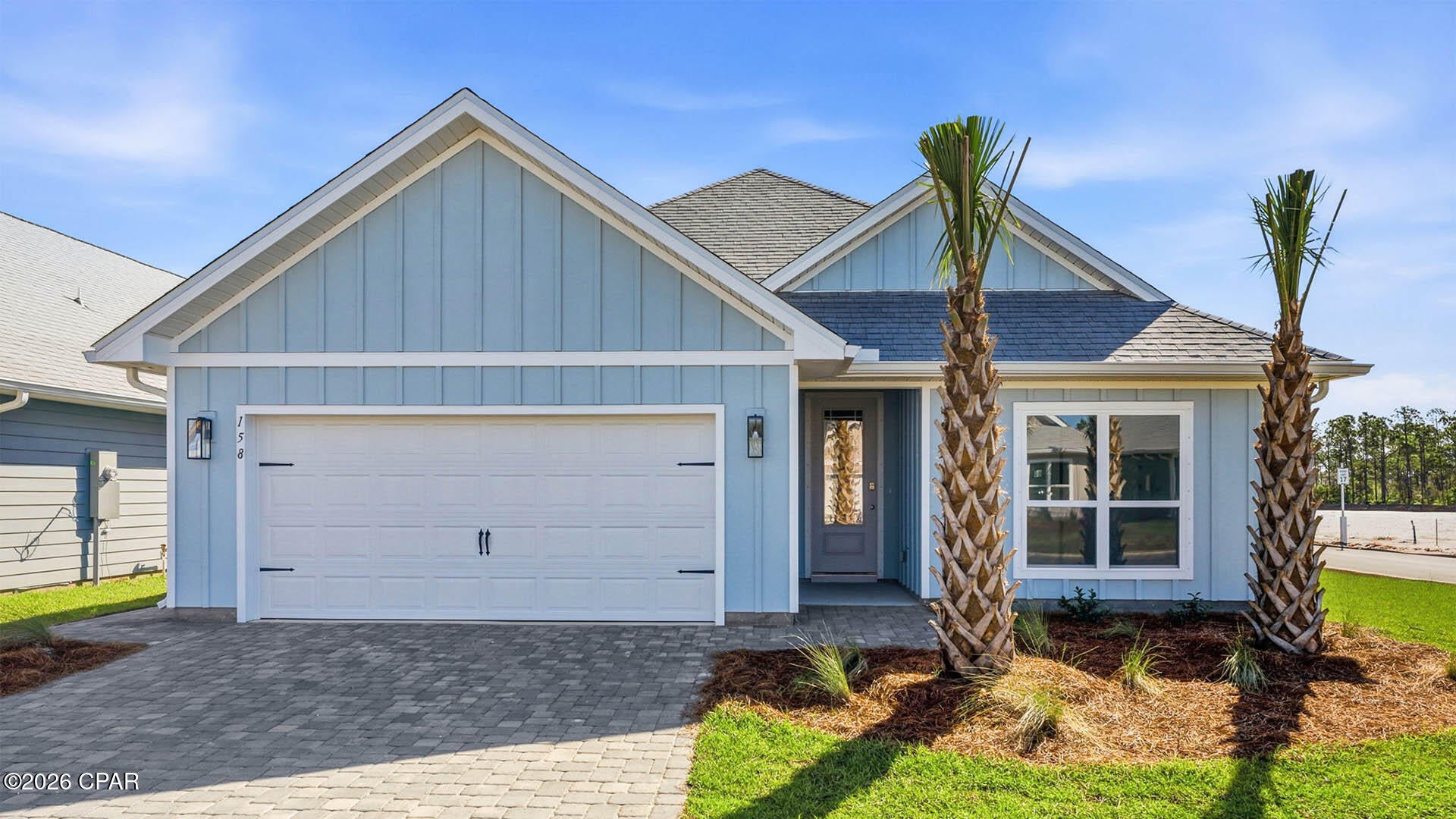 Welcome to 158 Porter Drive, a new home located at WindMark Beach in Port Saint Joe, Florida. As a part of our Emerald Series of homes, this beautiful single-story home boasts over 2,000 square feet of bright, open living and entertaining space as well as elegant, upgraded features. The Lily plan features four bedrooms, three full bathrooms, a spacious two-car garage, open floor plan design, and a large covered back patio.

As you enter the foyer, sleek EVP flooring leads the way to the living area and features two front bedrooms and a bathroom, with the fourth bedroom, third bathroom, and laundry room next to the garage entrance. The open concept living area is highlighted by the tall, vaulted ceilings and large windows, flooding this grand space with natural light and giving views to the covered back patio.

This gourmet style kitchen features a large kitchen island that sits looking into the family room and features a stainless-steel dishwasher, a farmhouse style sink, and beautiful, upgraded quartz countertops. The kitchen also features an electric stovetop range, a stainless-steel microwave and oven, a tile backsplash, and the walk-in corner pantry with built-in custom wood shelving.

On the other side of the kitchen, you will enter the secluded hallway to the primary suite which gives added privacy, elevated tray ceilings and three large windows. The elegant bath ensuite features an oversized tile shower with a glass door, separate soaking tub, dual sink vanity, stylish white cabinets with beautiful quartz countertops, and a large walk-in closet with custom wood shelving. Beyond the interior features and details, every home is equipped with Smart Home Technology. This thoughtful integration of technology ensures that your new home is perfectly designed to meet the demands of modern life.

On the outside of the home, there is quality Hardie® siding on all homes at WindMark Beach as well as outdoor showers. Exclusive to these Emerald series homes are concrete paver driveways, giving an even more upgraded look to your home. Enjoy quality materials and workmanship throughout, with superior attention to detail. Enjoy all the amenities the Windmark Beach community has to offer complete with beautiful new homes, local food, shopping, boardwalks, and beach access! Windmark Beach amenities includes two pools, BBQ grills, 11 dedicated beach accesses, the village center, boardwalk, and is pet friendly! The community is golf cart friendly, and dogs are allowed on the beach! We would love to give you a tour of our Lily plan today, connect with us today and see for yourself why WindMark Beach Emerald series homes are perfect for you!