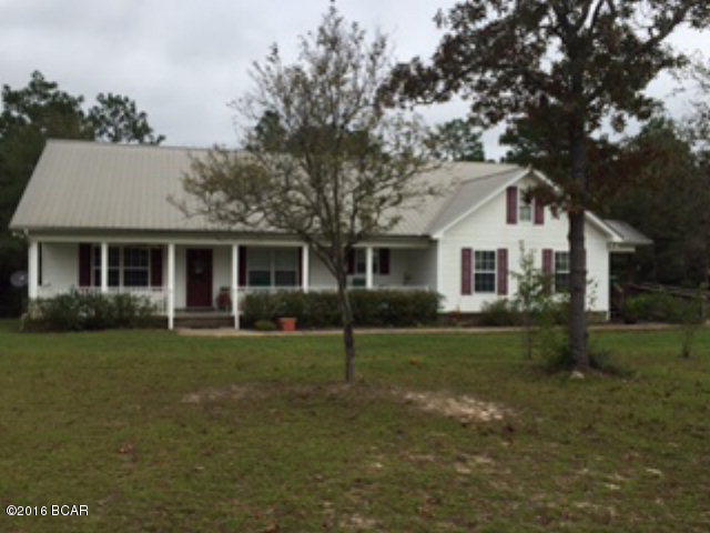 Spacious country home minutes from Chipley, Panama City, Panama City Beach, I-10 exit and Northwest Florida Beaches International Airport. This 4BR/3BA beauty has an open floor plan with living room, dining room and kitchen with a galore of cabinets and pantry. Back door access to a covered porch and deck waiting for your enjoyment. The master bedroom has a bath with whirlpool, separate shower, double vanity and tile floors. Two of the bedrooms are split off on other end of home with the fourth bedroom set up totally handicap equipped with its own outside entrance but can double for a den, office or whatever is needed. Its private bath has a handicap shower, toilet and sink. Nice front porch, lots of garden areas, circular drive, fencing, and plenty of room to build a garage or workshop. All this on 11.74 acres with paved road frontage.