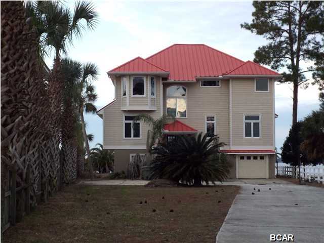 Bay front custom built 3 story home with dock in Lynn Haven offered as is. The property is on North Bay with access to the gulf. This 5 bedroom, 4 bathroom home features an unobstructed view of North Bay from every level and has an open floor plan, 2 HVAC systems and 2 water heaters. The 2nd floor has 2 large bedrooms with adjoining baths, the laundry room and one large room to include the living area, dining area and kitchen. The exterior features a long driveway with extra parking, a sprinkler system on separate meter, covered balconies along the back of the 2nd and 3rd floor and a covered porch on the bottom level. This home has a long dock Call today for a private preview. All ages, sizes and measurements approximate please verify accordingly.