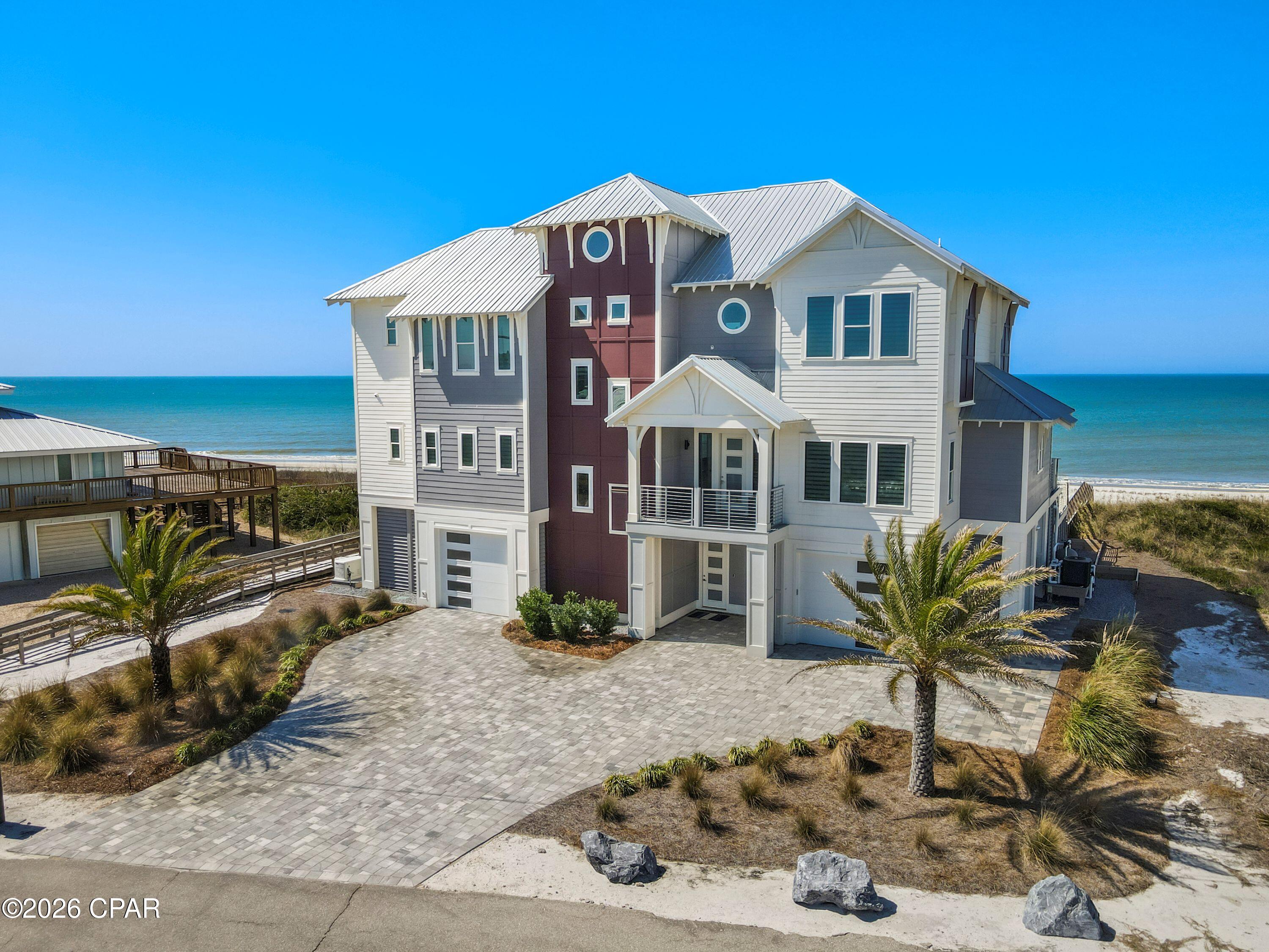 Introducing a Gulf-front luxury masterpiece on Cape San Blas--an absolute showstopper with undeniable WOW factor from the moment you arrive. This extraordinary 6-bedroom home features ensuite bathrooms in every bedroom, creating the perfect balance of privacy and luxury for family and guests. The ground level is pavered with abundant covered parking and generous space for entertaining. A private elevator services all three floors, providing convenience and accessibility throughout the home. The chef's kitchen is nothing short of spectacular, designed to impress with two large islands, extensive custom cabinetry, and top-of-the-line appliances including a Sub-Zero refrigerator/freezer, wine fridge, WOLF convection double ovens, induction cooktop, ice maker, and dishwasher. The stunning backsplash tile serves as a true centerpiece, while designer lighting fixtures throughout the home elevate the overall aesthetic. The expansive main living area, complete with a fireplace, opens onto a Gulf-front balcony overlooking the infinity-edge pool and hot tub. Outdoor living is taken to the next level with an outdoor shower and ample space to relax while taking in the breathtaking Gulf views with your private beach walkover The first living floor features two bedrooms with ensuite baths, a private office, convenient half bath, and utility space. On the third floor, a second living area with wine fridge, sink, and bar creates a perfect gathering space centered between the remaining four bedrooms. Plush carpeting invites comfort in each room. Two bedrooms face the Gulf with stunning views, while the other two enjoy views of St. Joseph Bay. The owner's suite is a luxurious retreat, featuring an elaborate bathroom, walk-in closet, and a hidden surprise--step outside to experience the private Gulf-front outdoor shower. While the home has not been used as a rental, rental projections are available, for a remarkable opportunity. Home also features Generac generator for piece of mind.