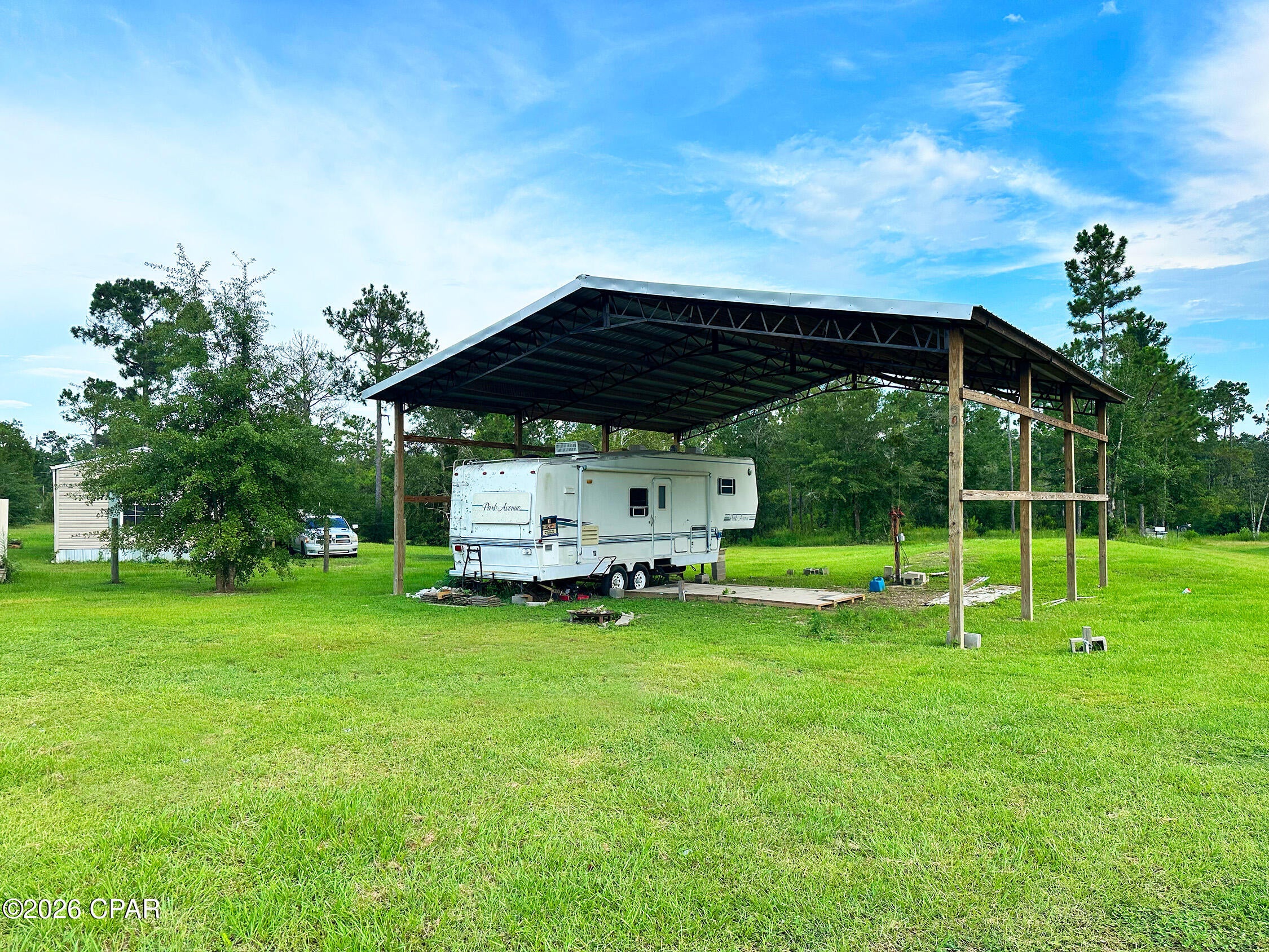 Escape to your own piece of paradise! This spacious 1.5+ acre property just north of Wewahitchka offers the perfect combination of privacy, convenience, and outdoor adventure. A well-maintained pole barn with a well, septic, and electric is already in place. The barn includes room and hookups for two RVs, making it an ideal getaway for family and friends--or a great starting point for building your dream home. Recent improvements include a reconditioned well pump, recently inspected septic system, and updated electrical connections. Located close to world-class freshwater fishing and less than an hour from several beautiful Gulf Coast beaches, this property puts you in the heart of everything the area has to offer. Currently being used as a month-to-month rental, it also presents an excellent investment opportunity at an attractive price. Whether you're looking for a weekend retreat, RV getaway, investment property, or an amazing homesite, this property is ready for you.