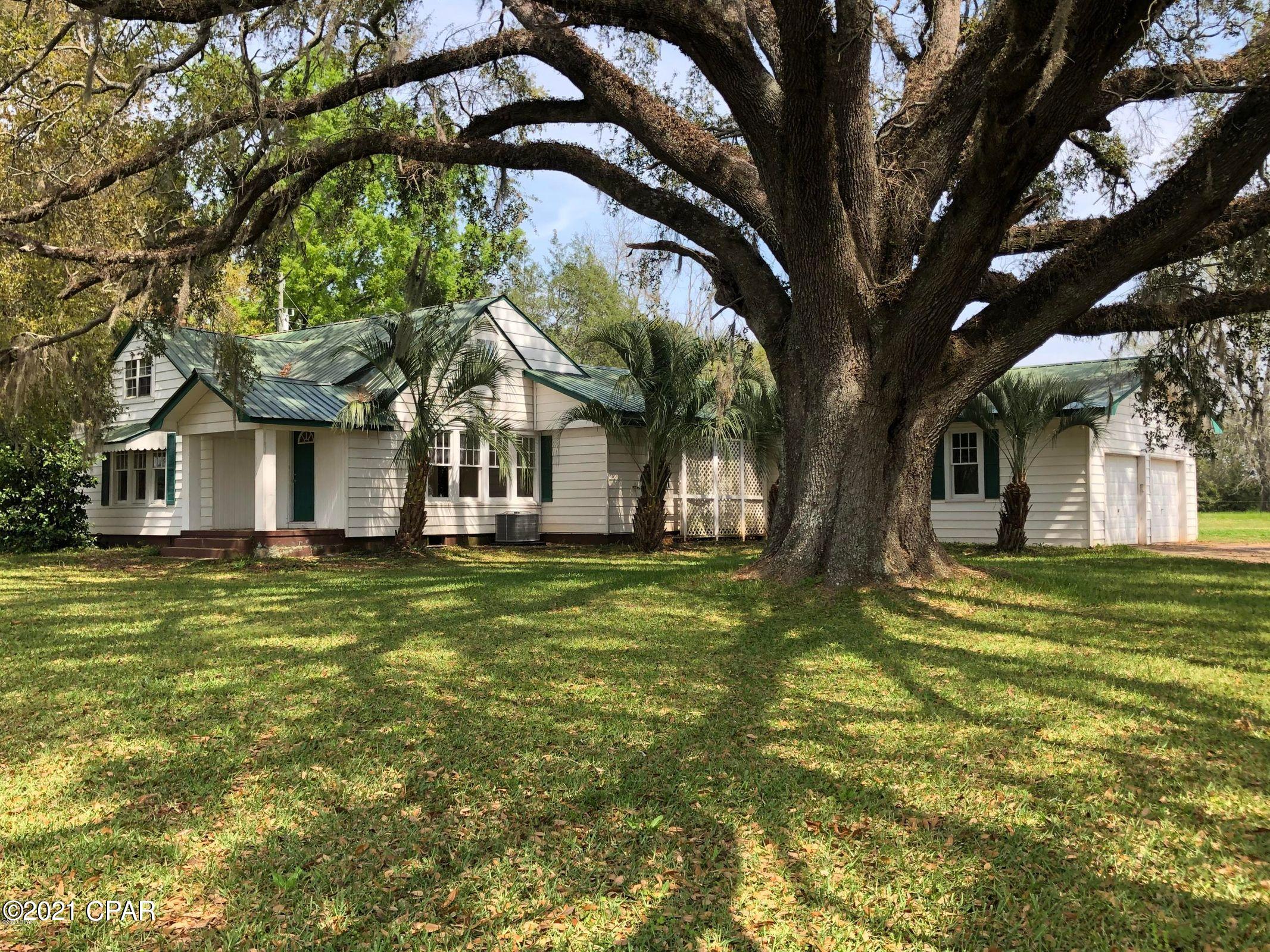 RECENTLY UPDATED WITH NEW PRICE. (see attached appraisal))  Big Country Home sitting among Huge Granddaddy Oaks. Home boast 5 bedrooms 3 baths , includes a 1 bedroom apt upstairs. Sitting on .85 acre With stunning views. Family room has a fireplace. Master bath has a Jacuzzi , SS appliances , new paint, new carpet and floor covering throughout home. Close to Fl.and Al state line. Rent the apartment for income or use for family or office.  Note-there is a Mobile home on an adjoining acre that can be purchased separately.