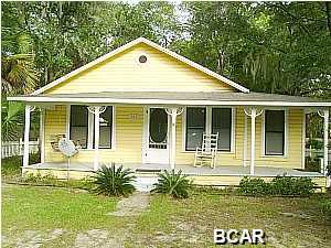 Cute Southern style home with large porch, completely fenced yard, outside storage building, separate dining room, split bedroom plan, washer and dryer connections.