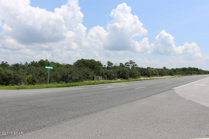 Almost 2 acres of vacant land on PCB PKWY. Approximately 340 feet of highway frontage and located on the corner of Gainous RD with a median cut through. Drive by the property today. It won't last long in the growing area of PCB, FL (All information approximate, if important, buyer must verify.