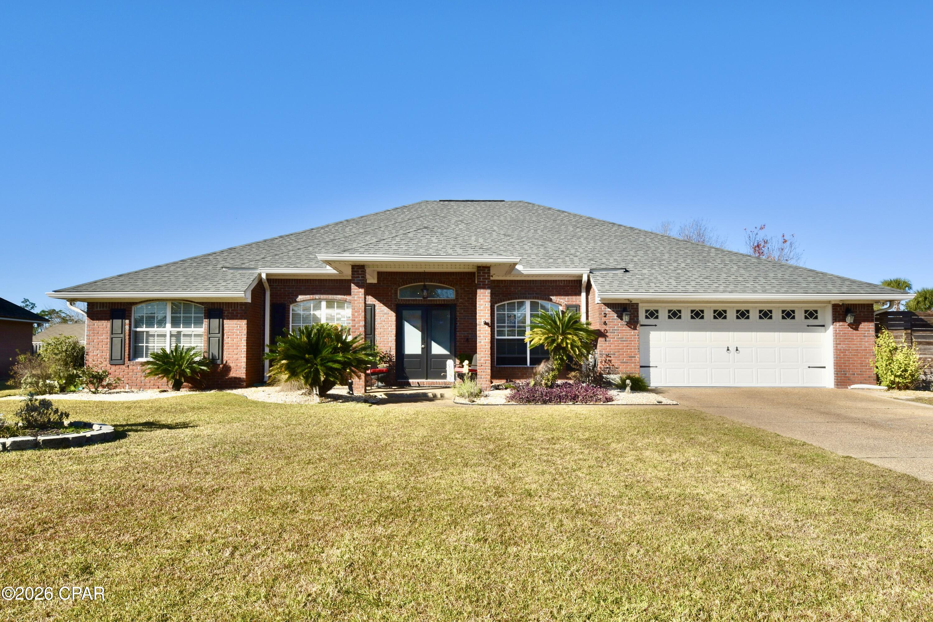 Welcome to this meticulously updated 4-bedroom, 3 full-bath brick residence with a screened-in pool, ideally situated in the highly desirable Woods II subdivision. Offering approximately 2,588 square feet of thoughtfully designed living space, this home is set on a generous 0.37-acre lot and features an oversized driveway, providing both functionality and curb appeal. Perfectly positioned in a central location, the property offers convenient access to premier shopping, dining, and leading medical facilities, while being approximately 20 minutes from both Tyndall Air Force Base and Naval Support Activity Panama City Beach. This home has undergone a comprehensive renovation between 2019 and 2021, reflecting quality craftsmanship and modern design throughout. Upgrades include durable tile flooring, as well as a fully reimagined kitchen equipped with quartz countertops, an undermount sink, pot filler, updated appliances, under-cabinet lighting, and an expansive walk-in pantry--ideal for both everyday living and entertaining.  The living area is designed to be both inviting and functional, featuring a stylish electric fireplace complemented by custom built-in cabinetry, creating a warm and sophisticated gathering space. The primary suite serves as a private retreat, complete with elegant French doors that open directly to the pool area, enhancing the home's seamless indoor-outdoor flow. The en-suite bathroom is well-appointed with dual vanities, a jetted soaking tub, a tiled walk-in shower with built-in seating, and a private water closet. The outdoor living space is equally impressive, offering a fully fenced backyard designed for privacy and relaxation. The in-ground Gunite chlorine pool, enclosed within a screened lanai, was resurfaced in 2021, providing both aesthetic appeal and long-term peace of mind. Additional features include a 16' x 10' powered storage shed suitable for a workshop or hobby space, a full irrigation/sprinkler system, a hard-wired security system with cameras and dual network video recorders, and a partially floored attic for added storage capacity.  This well-maintained property presents a rare opportunity to own a move-in ready home that combines modern upgrades, functional design, and exceptional outdoor living in one of the area's most established communities. Schedule your private showing today. All measurements are approximate and should be verified by the buyer if deemed important.