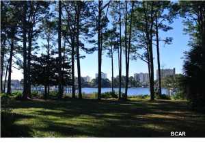 Unheard of these days - 3 acres on the GRAND LAGOON! I think you will agree this is one of the prettiest waterfront lots you will ever see! It is an enormous parcel of land with so many possibilities. Located next to Lagoon Estates, you will appreciate the property even more once you study the parcel map or survey. There is a 3000 sq ft home with fantastic views from so many rooms and angles. People love the North side of the Grand Lagoon because the night skyline includes beautiful condo lights. New Roof in 2012- Storm Shutters --- This is truly a waterfront investment for the future- Don't miss the boat! We were told a minimum of 24 units would fit on this property.