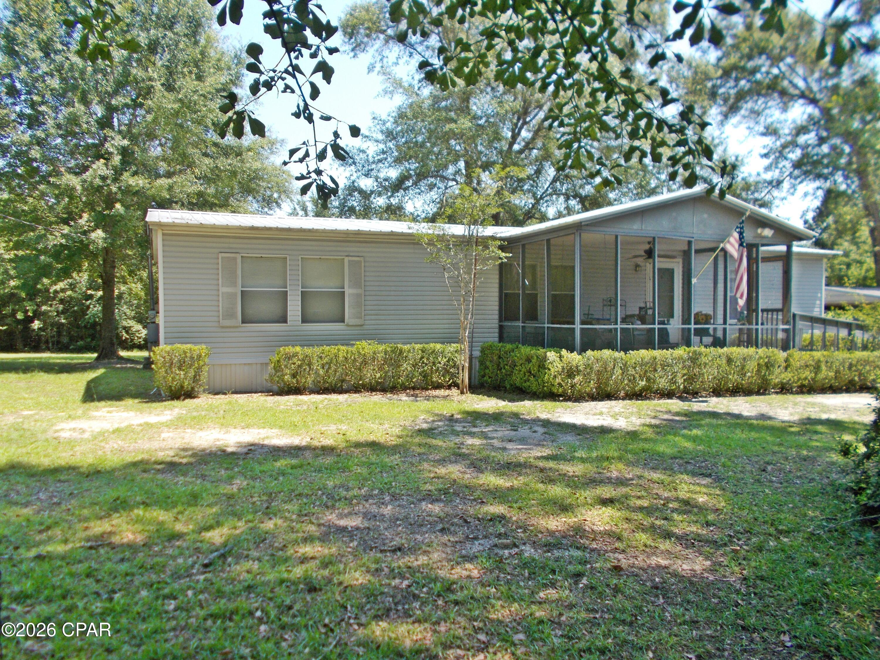 Very well maintained 3/2 Mobile home on almost 19 ac. with a beautiful Cypress Pond on it. This home has an open floor plan with living room, dining room and large kitchen for a smooth flow, the rooms have been freshly painted, large master bedroom with a walk in tub with jets in it,, the submergible pump was replaced this year, the a/c unit has been updated, a metal roof on the home, a large double carport with attached storage and also a pole barn tall enough to hold a motor home or large camper or numerous other toys There is appx. 680 ft paved road frontage on Church st. and appx 1100 paved road frontage on Lexington Lane, this home is a must see and want last long at this price.