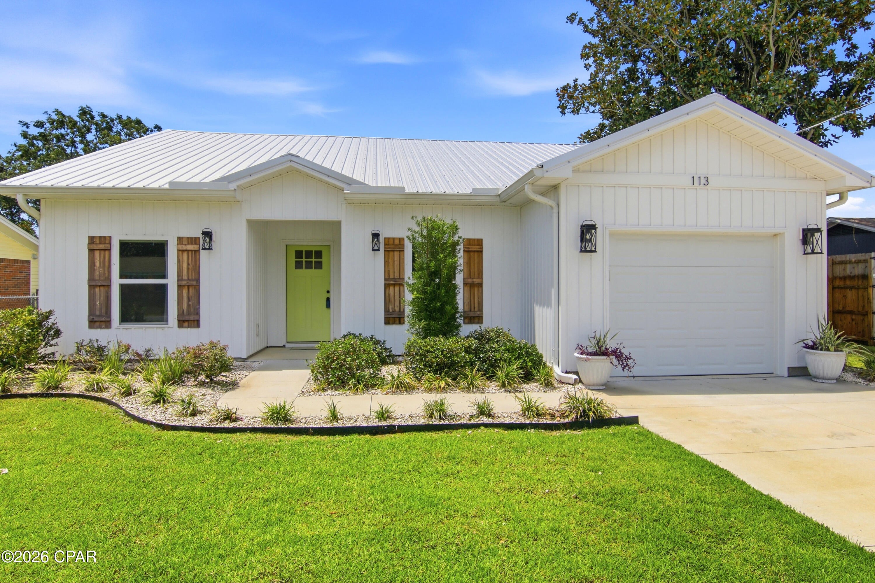 COASTAL CHARM, NO HOA, AND A LOCATION THAT PUTS PANAMA CITY BEACH AT YOUR FINGERTIPS! This Craftsman-style home at Gulf Highlands pairs relaxed beach style with everyday convenience, just minutes from Pier Park, the West End beaches, and Frank Brown Park.The crisp white exterior, metal roof, rustic shutters, and Leaf Filter Gutter Guards combine curb appeal with low-maintenance features.

Inside, the bright, open floor plan creates an easy flow between the kitchen and living spaces. The kitchen is both stylish and functional, featuring white quartz countertops, generous cabinetry, ample workspace, and Smart Stainless Steel Appliances that bring added convenience to everyday living. Tray ceilings in the living area and primary bedroom add character and dimension while enhancing the home's open, airy feel.

Outside, there's even more to appreciate. The landscaped yard features a sprinkler system and offers plenty of room for entertaining, relaxing, or enjoying the Florida sunshine. A backyard STORAGE BUILDING WITH SHELVING provides a convenient place for lawn equipment, beach gear, tools, and more. EXTRA PARKING has been added with pavers, giving you additional space for vehicles, guests, or a golf cart. The garage door opener is also included for added convenience.

When you're ready to get out and explore, you're close to some of the best of PCB. Take a short walk to Scott Field Park with a playground, basketball court and pavilion with picnic tables. Enjoy easy access to Frank Brown Park, nearby walking and biking trails, the dog park, community pool, shopping, restaurants, entertainment, and the sugar-white sands of Panama City Beach.

Best of all, there is NO HOA and NO FLOOD INSURANCE REQUIRED, giving you more freedom and fewer ongoing expenses. Whether you're looking for a primary residence, beach-area retreat, or simply a home that keeps you close to everything you love about PCB, this one deserves a closer look!