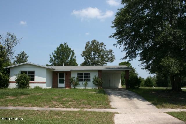 Available Now!  Sturdy block & brick home on large corner lot.  Covered carport and storage room.  Kitchen has stove & refrigerator.  Central AC & Heat.  Terazzo tile floors throughout except carpet in spacious living room.  Golf course, crystal clear lakes for fishing & swimming close by.  Please TEXT for info or showing appt.