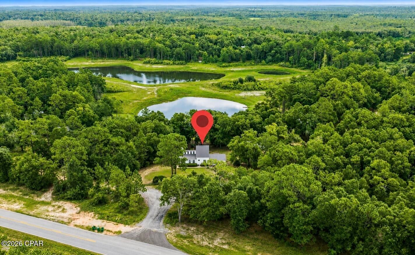 Lakefront living on beautiful Payne Lake. Situated on 1.45 private acres just outside Chipley, this waterfront property offers privacy and peaceful country living with Panama City, the Gulf Coast, and Tyndall Air Force Base all within an easy drive. The open floor plan is filled with natural light and features expansive windows overlooking the lake. The spacious kitchen connects to the living and dining areas, making it ideal for everyday living and entertaining. Outside, a large deck shaded by mature oak trees provides the perfect place to enjoy the view, whether you're having morning coffee or watching the sunset. Spend your days fishing, kayaking, paddleboarding, or enjoying the wildlife right from your backyard. A separate efficiency mother-in-law suite with its own private entrance, kitchenette, and full bath offers flexibility for guests, multi-generational living, or rental income. Also, could be perfect for a shop and man cave or she shed. With no HOA and plenty of room for boats, RVs, hobbies, gardens, or future expansion, this property offers the space and freedom to enjoy lakefront living.