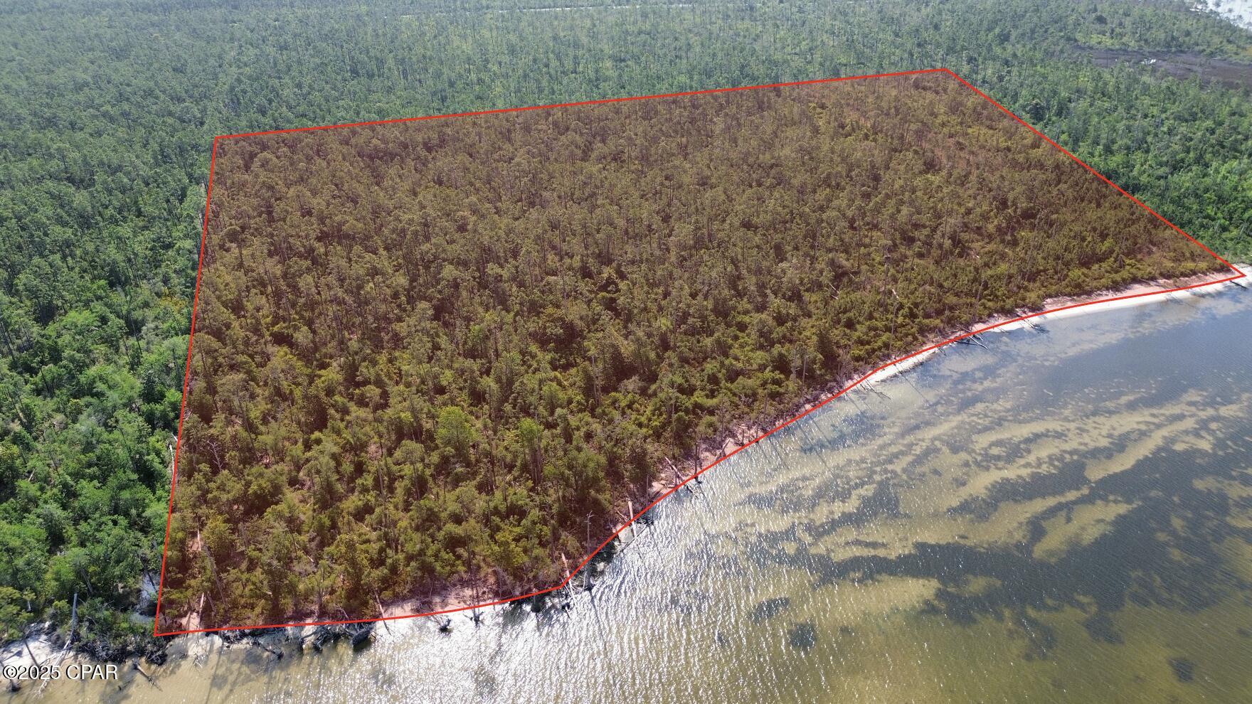 +/- 18.5 waterfront acres on East Bay. Adjacent to Eastern Shipbuilding and Tyndall Air Force Base. Municipal utilities available along Highway 2297. Additional +/- 80 acres surrounding property also available. +/- 750ft of waterfront. Bay County - Conservation Habitat zoning allows for 2 residential units per acre. Bay Co Parcel IDs: 04005-020-000 & 04005-010-000.