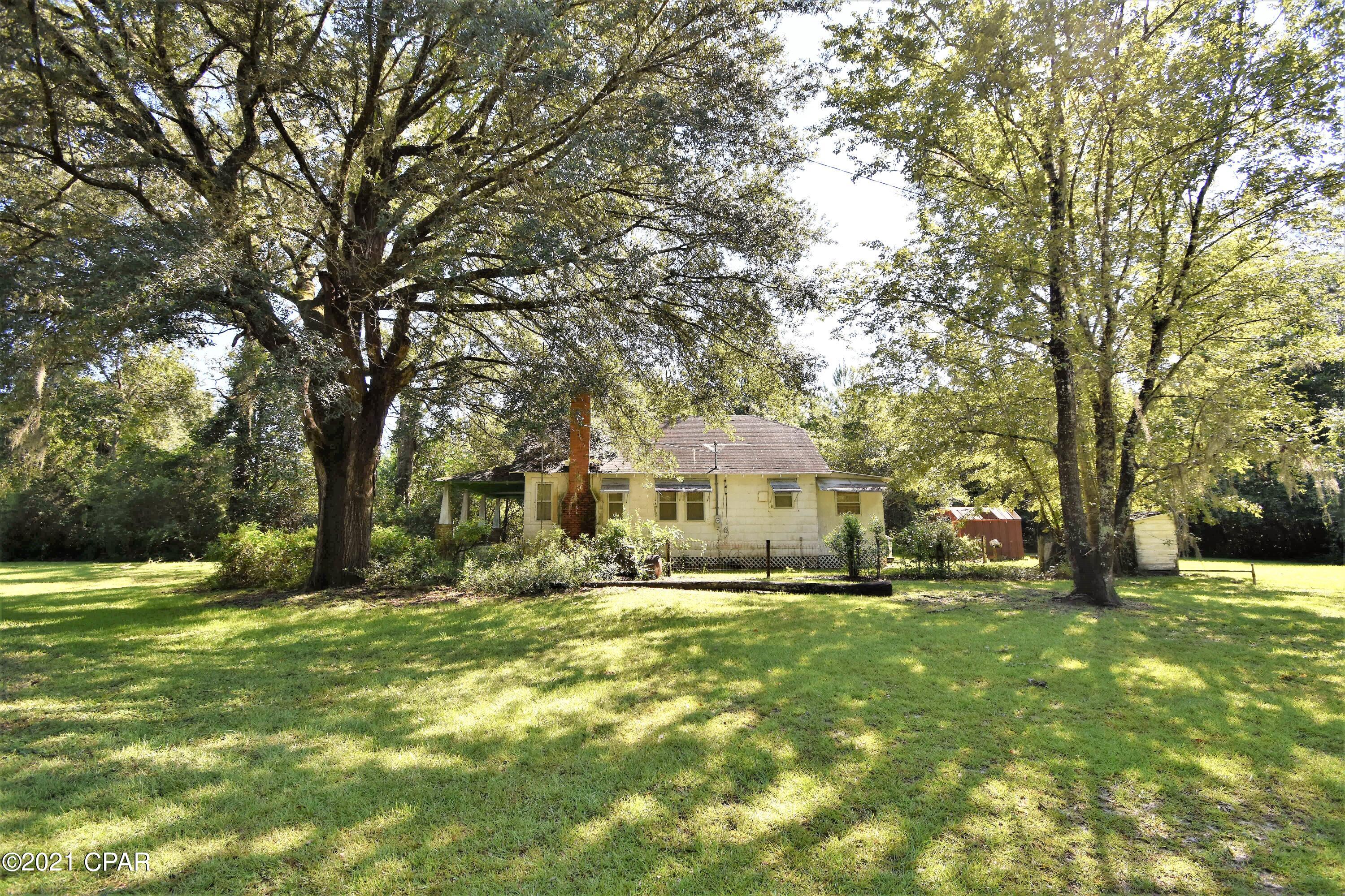 Old country fixer upper located in the city limits of Westville on a gorgeous high-and-dry lot! It will need a cash buyer, but has a lot of potential! The original hardwoods are throughout most of the home. There is a living, dining, kitchen, utility, bathroom, and two bedrooms. The yard is huge, features old oaks, scuppernogs, a metal storage shed, another wooden outbuilding, and a couple fenced areas. Paved road access. The roof actively leaks and will need replacement. Seller does not believe that the septic system works. With a vision and some renovating this home can be returned to its former glory!
