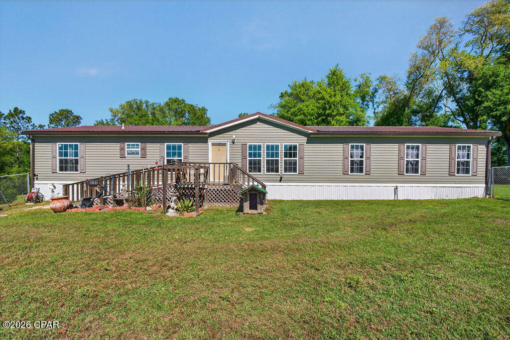 Situated just off Highway 77 in Graceville, this spacious 4-bedroom, 2-bath double wide mobile home offers 1,976 square feet of comfortable living space on 3.50 cleared acres. Inside, you'll find a large living room plus an additional family room featuring a cozy wood-burning fireplace, providing plenty of space for relaxing or entertaining. The open kitchen features stainless steel appliances, abundant cabinet storage, and a functional layout perfect for everyday living. The spacious master suite includes a cozy sitting area, while the master bath offers a garden tub, separate shower, and ample space to unwind. A split-bedroom floor plan provides privacy with three additional bedrooms located on the opposite side of the home. Outside, the property is well-equipped with a 30x50 garage and a 16x60 storage building complete with window A/C, offering endless possibilities for storage, hobbies, or workspace needs. For added peace of mind, the home also includes a full-property Generac system. Enjoy peaceful country living with room to spread out while still being conveniently located near town amenities.