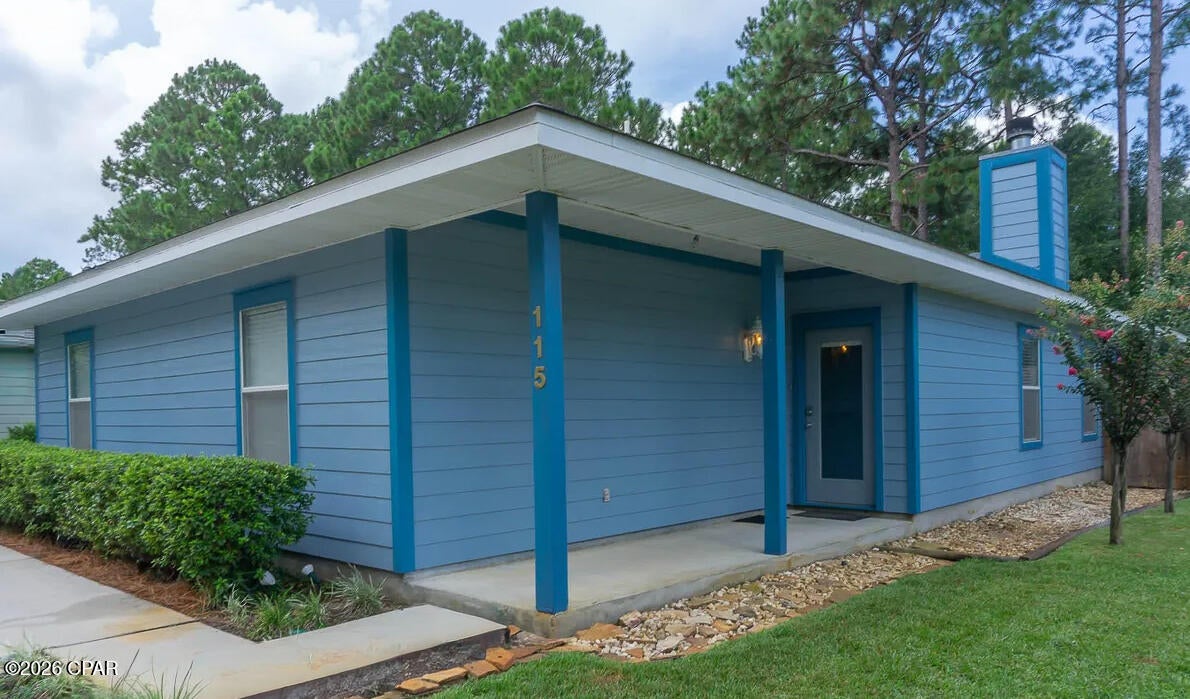 COMING SOON - NO SHOWINGS - Some houses you tour. This one you settle into.

It starts on the corner lot, under longleaf pines and oaks that throw real shade by late afternoon -- the kind that makes the back yard usable in August. Behind the full fence there's a fire pit, a garden, stone and gravel walkways, crape myrtle and palm, all of it kept green by full irrigation off a well pump. Come through the double gate on E Russel Ave and there's room to park the boat, the RV, whatever you tow.

Inside, 1,610 square feet of open-concept living under wood floors, with a wood-burning fireplace for the three weeks a year the Panhandle earns one. Craftsman moldings in 6'' and 4'' run throughout -- the detail you notice on the second walkthrough, not the first. The kitchen keeps light shaker cabinets, granite counters and a breakfast bar built for morning conversation, with the laundry room just off it. Three bedrooms, three full baths, every bedroom with its own -- no one negotiates for the shower. Travertine floors and surrounds throughout, with a walk-in travertine shower and jetted tub in the primary.

Evenings belong to the screened back porch.

Town of Santa Rosa puts you minutes from shopping, dining and schools, under two miles from the Choctawhatchee Bay boat launch, and ten minutes from Emerald Coast sand!