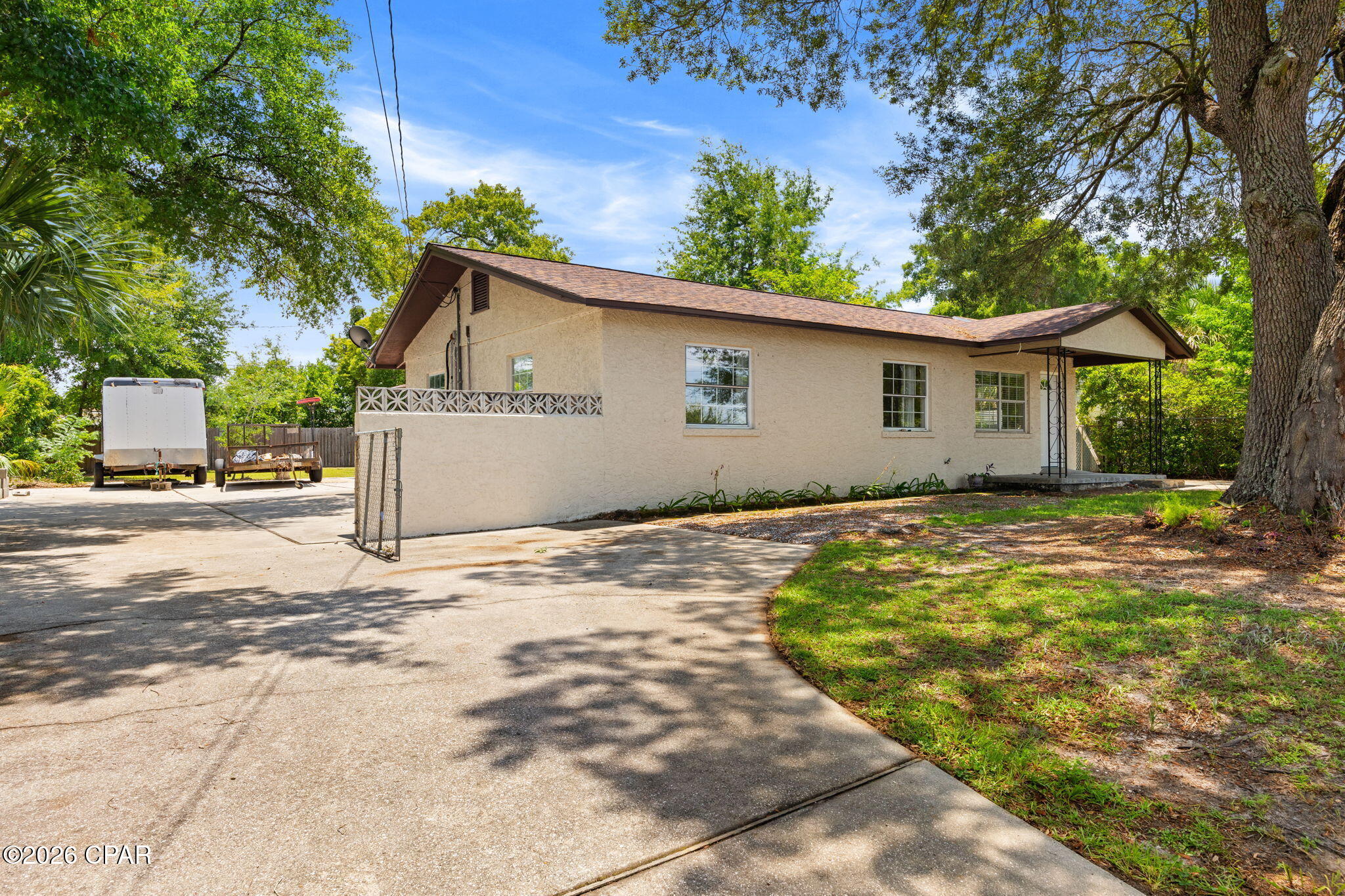 Charming 3-Bedroom Remodeled Home with Expansive Outdoor Space | Prime Panama City Location.


Welcome home to this beautifully updated 3-bedroom single-story residence featuring a fresh, modern interior and an incredible fully fenced lot perfect for toys, trailers, and outdoor living.


The exterior welcomes you with a clean stucco façade, a newer roof (replaced 2019), and mature shade trees framing the property. What truly sets this home apart is the spacious driveway setup: two driveways including one extra-wide design that allows you to easily pull straight through into the side yard and backyard. 


The entire yard is fully fenced with three convenient gates--including a massive 18-foot rear gate opening directly onto the 20-foot-wide alley right-of-way behind the home. This layout makes parking boats, campers, trailers, or extra vehicles effortless--no backing in required.


Inside, the home shines with recent extensive remodeling. Enjoy brand-new floors, fresh paint throughout, updated lighting, new ceiling fans, and crisp new baseboards. The kitchen has been completely transformed with all-new cabinets, beautiful countertops, and modern stainless steel appliances. The kitchen remodel opened the space up more, with a flowing layout that connects the kitchen seamlessly to the rest of the home.


The highlight is the huge living/den area--a massive, light-filled space with soaring ceilings, exposed wood beams, and a striking fireplace with decorative tile surround. This flexible area is perfect for entertaining, relaxing, or family gatherings. The kitchen remodel also created a versatile bonus room, ideal for a home office, study area, or oversized pantry.


With only a 3-year-old A/C system, this home offers comfort and peace of mind alongside its stylish updates. Best of all, the location is fantastic--conveniently situated in Panama City and just minutes from the newly revitalized downtown Panama City, with its vibrant shops, restaurants, entertainment, and waterfront attractions.


Whether you're looking for a comfortable family home or a low-maintenance property with room to store your Florida lifestyle toys, this one checks every box.


Ready to make it yours? Schedule your private showing today--this gem won't last long!