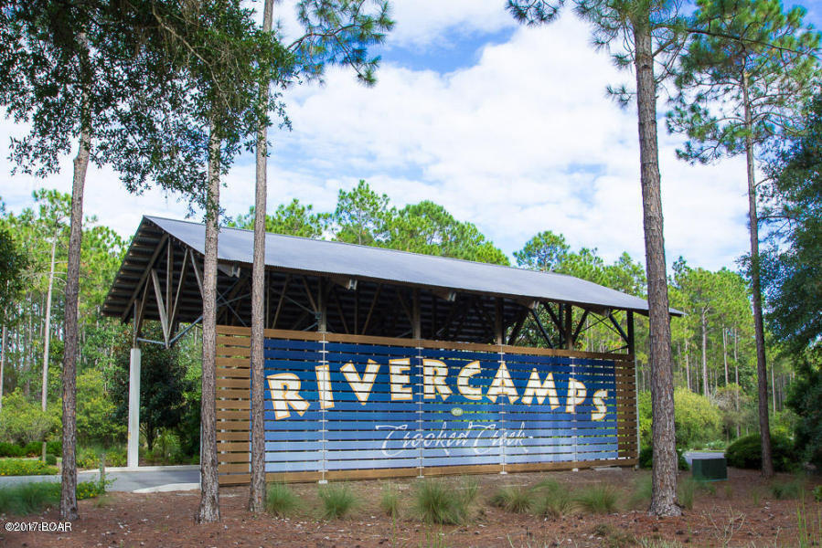 Build your dream home in RiverCamps! OWNER MOTIVATED!!  Great deal on this wooded lot in a gated waterfront community, in a very convenient location.  Community Amenities include the 25,000 square ft RiverHouse with community pool, pavilion, library, meeting room with commercial kitchen, and fitness center. 

 Enjoy over 7 miles of walking trails, an owners campground, boat docking, boat parking and launching facilities. No build out on homesites. If you love the outdoors, you will love this location!  Survey available.