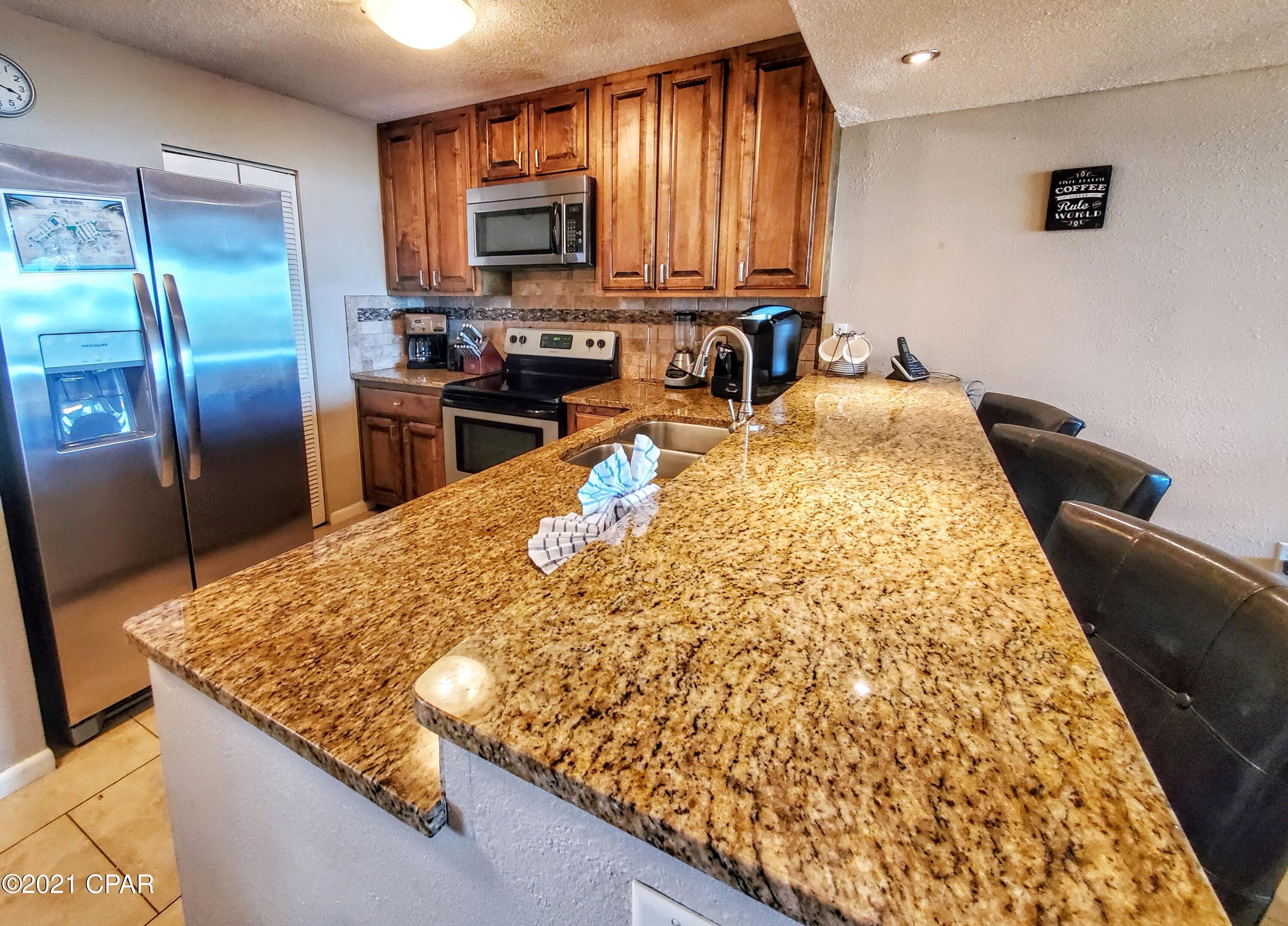 Beautifully remodeled 2 bedroom gulf front condo with deeded covered parking space. This condo offers custom cabinets, granite countertops, tile floors through out, stainless steel appliances, washer and dryer, great gulf views, and much more. The brand new sliding doors and windows were just installed this spring adding a tremendous value to the new buyers. The Dunes of Panama offers 3 Pools, Tennis Courts, Basketball, Free WiFi, Fitness room, Volleyball, Shuffleboard, Outdoor BBQ grills, Deli and Souvenir Shop. Chair and Beach rental services, and much more. Measurements are appx. Please verify if important.