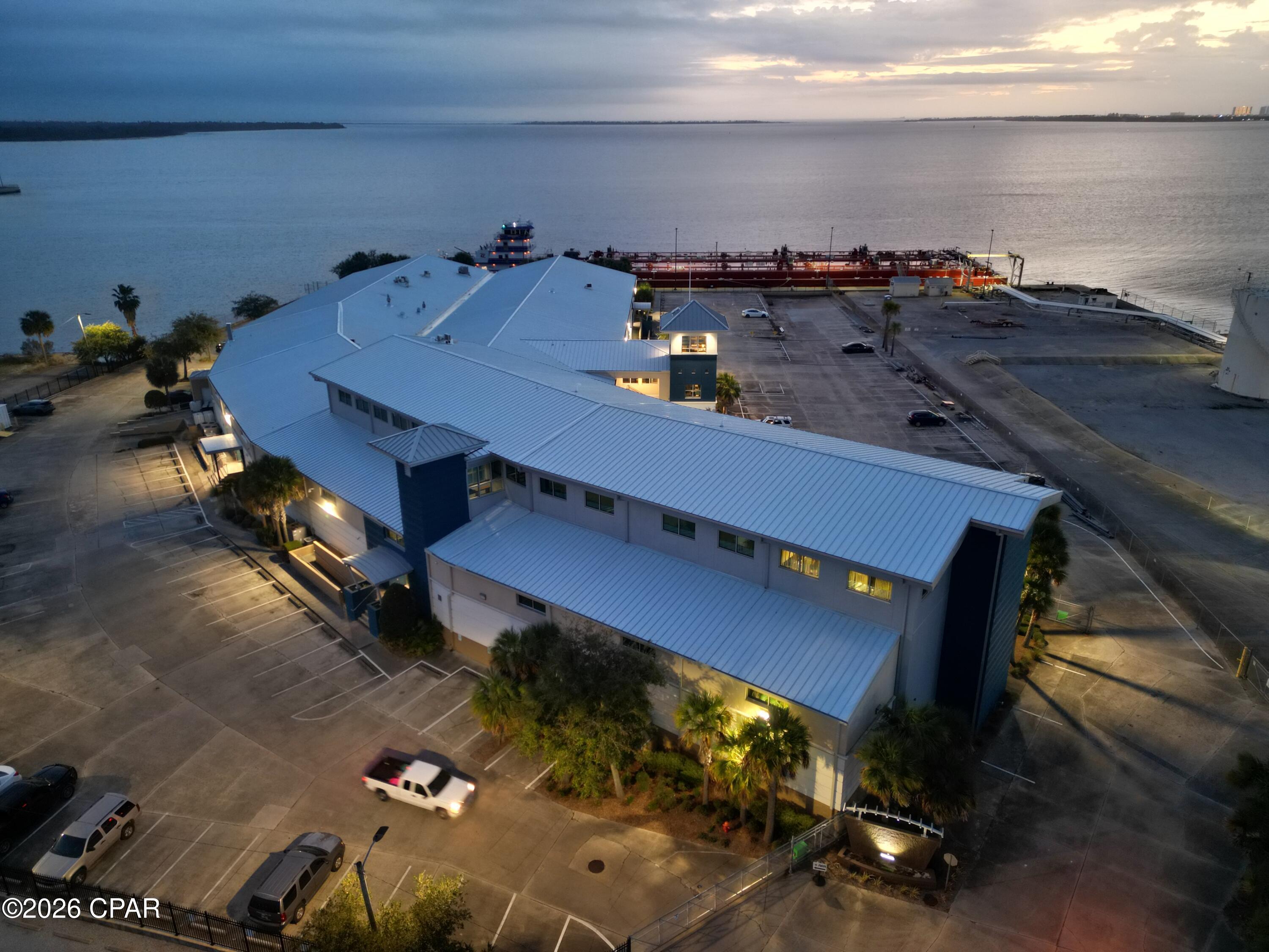 This 3rd story, waterfront Class A office has great City, Marina, and St. Andrews Bay views.  This space was completely redone in 2021 and has been lightly used since.  It has room for receptionist/foyer.  Modern Kitchen/Cafe/Supply; 11 private offices w/glass storefronts, 10 each cubicles included, conference room, data room, spacious feel with ceilings from 10' to 16' height.  Wind rated 186 mph.  Very efficient floorpan.