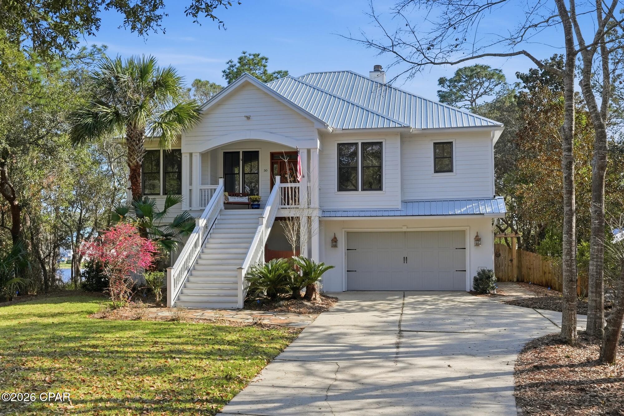 WATERFRONT • DEEP WATER BOAT DOCK • NO HOA • DOLPHINS Discover the beauty of coastal living in this inviting waterfront retreat, where peaceful surroundings towering live oaks and classic Lowcountry architecture create a timeless sense of place. Tucked within a quiet, established neighborhood with no HOA, the home offers both privacy and freedom while remaining just a short drive to the beach and coastal attractions. Inside, walls of windows flood the home with natural light and frame tranquil water views. The open floor plan creates a seamless flow between the living, dining, and kitchen areas--perfect for entertaining or simply enjoying everyday life by the water. Designed with flexibility in mind, the home features a separate living area ideal for older children, guests, or multi-generational living complete with elevator, providing both comfort and privacy when hosting family and friends. Step outside and experience the true charm of waterfront life. Relax and watch dolphins glide through the water, or head out for a day on the water from your deep-water boat dock with lift, offering convenient access for boating and coastal adventures. Surrounded by mature landscaping that enhances both beauty and privacy, the property feels like a peaceful retreat while still being close to everything the coast has to offer. Blending abundant windows, open living spaces, classic coastal design, and exceptional waterfront access, this home captures the essence of relaxed living--where every day feels like a getaway.