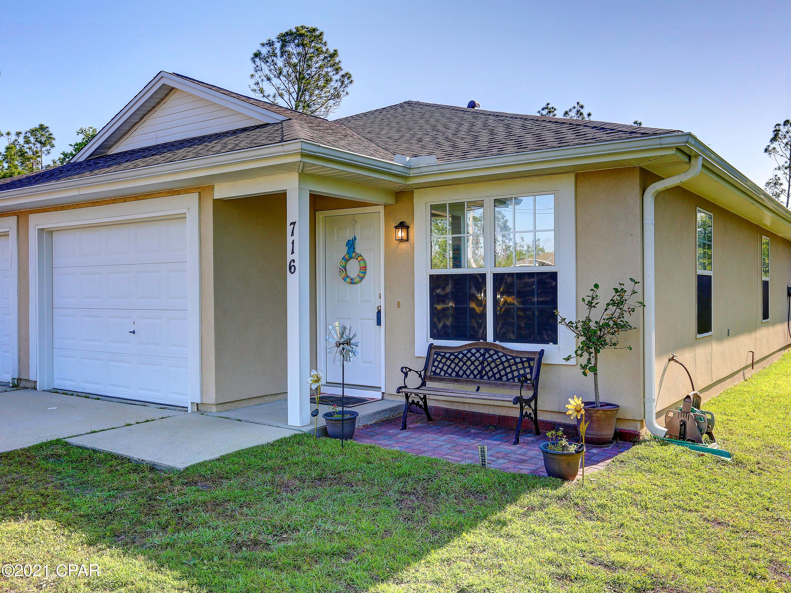 Charming 3/2 duplex, with a single car garage in the desirable Lynn Haven.  Home offers an open floor plan, large eat in kitchen, complete with a breakfast bar, pantry, newer stainless appliances,  formal dining area, tile floors,  the HVAC has been replaced, new roof and roof in 2019, and so much more. Home is situated on  corner lot on a quiet cul de sac and close to schools, shopping, restaurants  and a beautiful park  that  all ages will enjoy. Home is move in ready with NO  All ages, sizes. including sq. ft. are approximately, measure if important.