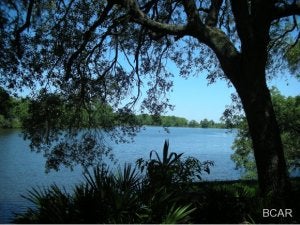 This is a gorgeous property right on Lynn Haven Bayou. Three lots combined with North Bay access for a small boat, kayak or jet ski. The huge Heritage oak trees are magnificent! Click on the VT link to see your waterfront view. (All measurements are approximate.Please verify all dimensions)
