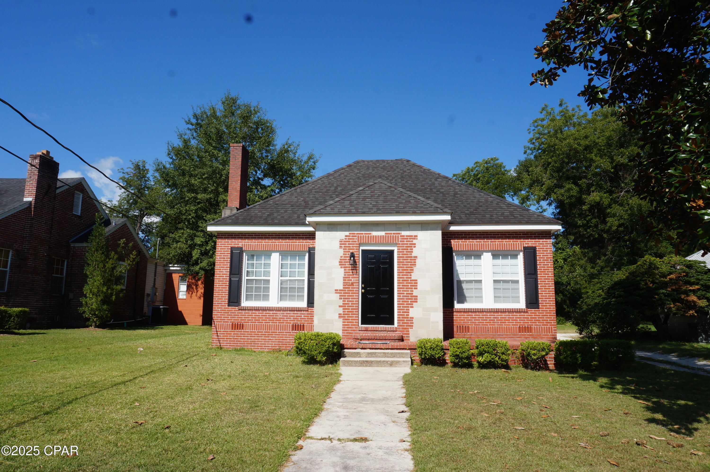 INVESTMENT PROPERTY! 

Property has a long term tenant. 

Charming three-bedroom, one bathroom home in the heart of historic downtown Marianna. This inviting property blends classic details with modern comfort, featuring refinished original hardwood floors, 10-foot ceilings, and abundance of natural light from numerous windows. Transoms above interior doors remain to promote airflow from era before central heating and air, adding character and charm. The galley kitchen offers a breakfast nook, beadboard paneling, tile floors, and stainless-steel appliances, making it a functional space for daily meals and entertaining. The spacious living room centers around a fireplace with gas logs (gas line inspection recommended before use). A formal dining room provides versatile space for gatherings. Two coat closets at the front and a hallway closet offer ample storage. The home sits on a quiet street with a neighborhood feel, while remaining conveniently close to downtown amenities, shopping, Jackson Hospital, and Chipola College. Built with center-block walls and brick veneer, the property is well-insulated and energy-efficient. The driveway is shared with the neighboring home. Additional highlights: Built-in bookshelves in two bedrooms- Energy-efficient insulation for lower utility costs- Close proximity to downtown shops, dining, and local institutions- Classic architectural features paired with modern updates. Don't miss this opportunity to own a piece of Marianna's historic charm with practical, everyday conveniences. Schedule a showing today to experience the warmth and potential this home offers.