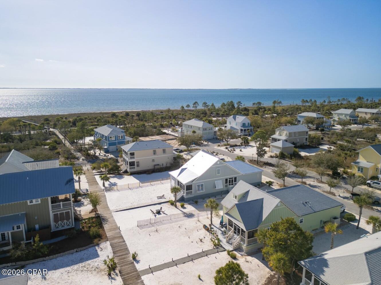 Tucked along one of Windmark Beach's most desirable boardwalks, 106 Salt Air Court, in Fisherman's Village, offers a seamless connection to the coast--where morning walks to the Gulf and evenings under open skies become part of everyday life. This single-level beach cottage is designed for ease, comfort, and the kind of relaxed luxury that defines Florida's Forgotten Coast. Positioned directly on a primary beach boardwalk, owners and guests enjoy a quick, effortless stroll to the shoreline just moments away. Equally appealing is the home's close proximity to the vibrant Windmark Beach Village Center, where a lagoon-style pool, dining, shops, and gathering spaces create a true coastal lifestyle experience. Built in 2018, the home features a thoughtfully designed layout with three well-sized bedrooms, two bathrooms, and a garage--ideal for both personal use and vacation rental potential. Luxury vinyl plank flooring runs throughout, offering durability with a refined coastal aesthetic. Outdoor living is just as inviting, with a screened porch overlooking the boardwalk--perfect for unwinding after a day on the beach--and an expansive paver patio designed for entertaining under the coastal sky. The recently replaced Trex boardwalk adds both value and peace of mind for years to come. Windmark Beach is known for its miles of waterfront trails, multiple beach access points, and a welcoming community atmosphere. Just a short drive away, Port St. Joe offers additional dining, shopping, marinas, and access to the pristine waters of St. Joseph Bay. Whether you're seeking a second home or a high-performing vacation rental, this property captures the ease, charm, and enduring appeal of life along the Gulf.