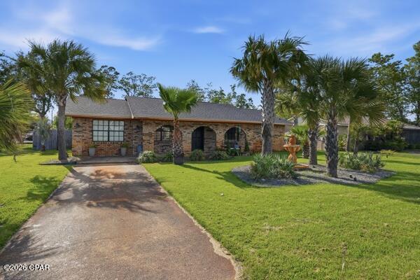 CURRENTLY UNDER CONTRACT, SELLER WILL CONSIDER BACKUP OFFERS - Welcome home to this charming all-brick beauty in the highly desirable Lynn Haven area! Perfectly situated on a large corner lot, this spacious 3-bedroom, 2-bath home offers room for everyone with multiple living areas and endless flexibility.

From the moment you walk in, you'll love the warm and inviting feel, featuring a formal living room, comfortable family room, and a large bonus room that could easily be used as a 4th bedroom, home office, playroom, or guest space. Whether you need room to grow, work from home, or entertain, this home offers options to fit your lifestyle.

The open kitchen is ideal for gathering, complete with a cozy eat-in breakfast area plus a separate formal dining space for family dinners and holiday entertaining. Stylish shiplap accent walls add charm and character, while the beautifully landscaped yard creates fantastic curb appeal.

Major updates have already been taken care of, including updated electrical, a newer roof (2022), A/C system (2021), and tankless gas water heater (2021), giving buyers added confidence and peace of mind.

Step outside to enjoy the fully fenced backyard featuring an above-ground pool, perfect for cooling off on warm Florida days, entertaining family and friends, or simply relaxing at home. The beautifully maintained yard is enhanced by a sprinkler system with its own well pump, helping keep the landscaping lush and green year-round. The property also offers side gates for boat, trailer, or oversized vehicle parking, adding both convenience and versatility.

Located close to shopping, schools, dining, and major roadways, this home combines space, comfort, and convenience in one fantastic package.