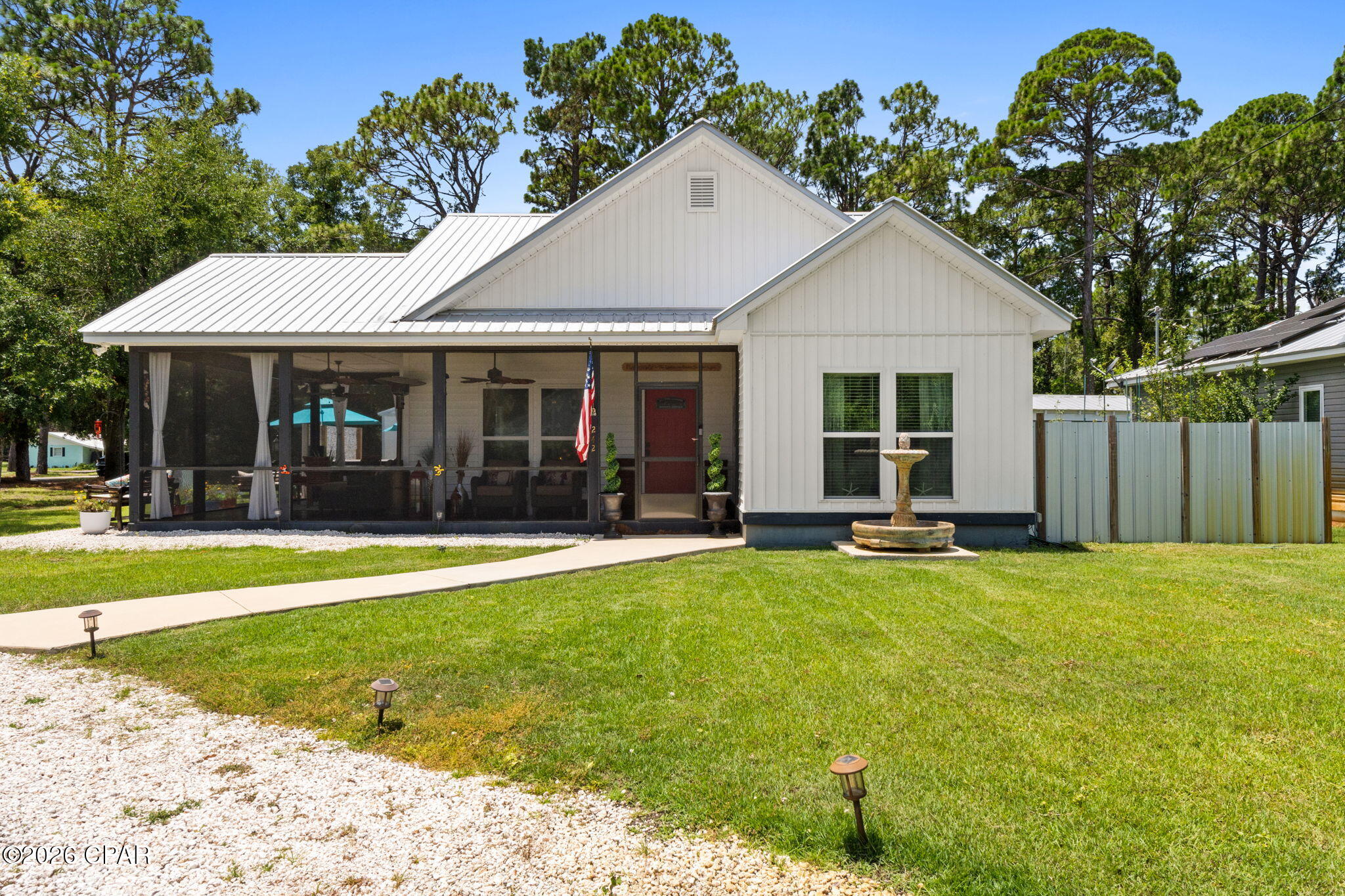 APALACH CHARM UNLOCKED!!  Discover the perfect blend of quality craftsmanship, modern upgrades & laid-back coastal charm in this beautifully maintained custom 3BR/2BA home. Situated on an oversized corner lot beneath the shade of mature oak trees, this inviting property offers exceptional indoor & outdoor living. Inside, you'll love the bright open floor plan featuring 9'+ ceilings throughout, soaring 12' vaulted ceilings in the main living area & a spacious gourmet kitchen designed for gathering with granite countertops, custom cabinetry & a stunning butcher block island that serves as the heart of the home. Step outside to the expansive wraparound screened porch where you can enjoy your morning coffee, unwind after a day on the water or entertain family & friends in complete comfort. The backyard is an entertainer's dream with a premium Hot Springs hot tub, authentic Forno Bravo pizza oven, propane cooker, rear deck & two versatile outbuildings perfect for a workshop, hobby space or additional storage. A newly constructed carport adds convenience while numerous upgrades provide peace of mind. Located within walking distance of the local school & dog park, this home is perfectly positioned to enjoy everything Apalachicola has to offer. Hop on your golf cart for a quick ride to the city's charming downtown filled with locally owned restaurants, boutique shopping, art galleries & historic waterfront attractions, or spend the day exploring 3 beautiful nearby white-sand beaches, boating, fishing & kayaking along Florida's Forgotten Coast. Public access to the popular Battery Park boat ramp is only about five minutes away, providing easy access to Apalachicola Bay & the Apalachicola River. This exceptional property delivers the ideal combination of comfort, convenience & the relaxed coastal lifestyle you've been searching for. Schedule your private showing today. Call for your private tour & LIVE THE BEACH LIFE!