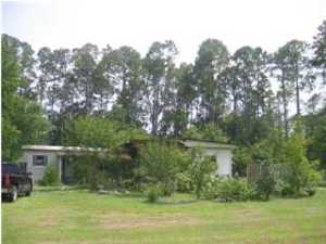 Income and investment property! This property has heavy commercial zoning which will cover almost any business you would like to operate. Great opportunity since this parcel fronts busy four lane Hwy 77. Get your offer in fast, this area is a hotspot with developers. Zoned C-3 Heavy commercial. Mobile home has no value but is presently providing rental income and could possibly serve as an office, and what a plus to have electric, water, and septic already to the lot. Property has 131 commercial footage on busy Highway 77 by 187 deep and access crossing to four lane highway. No impact fees! This area is growing and within twenty minutes of the PCB International Airport. Take advantage of this while the prices are at an all time low! Please do not approach occupant of mobile home. Call  for viewing of property.