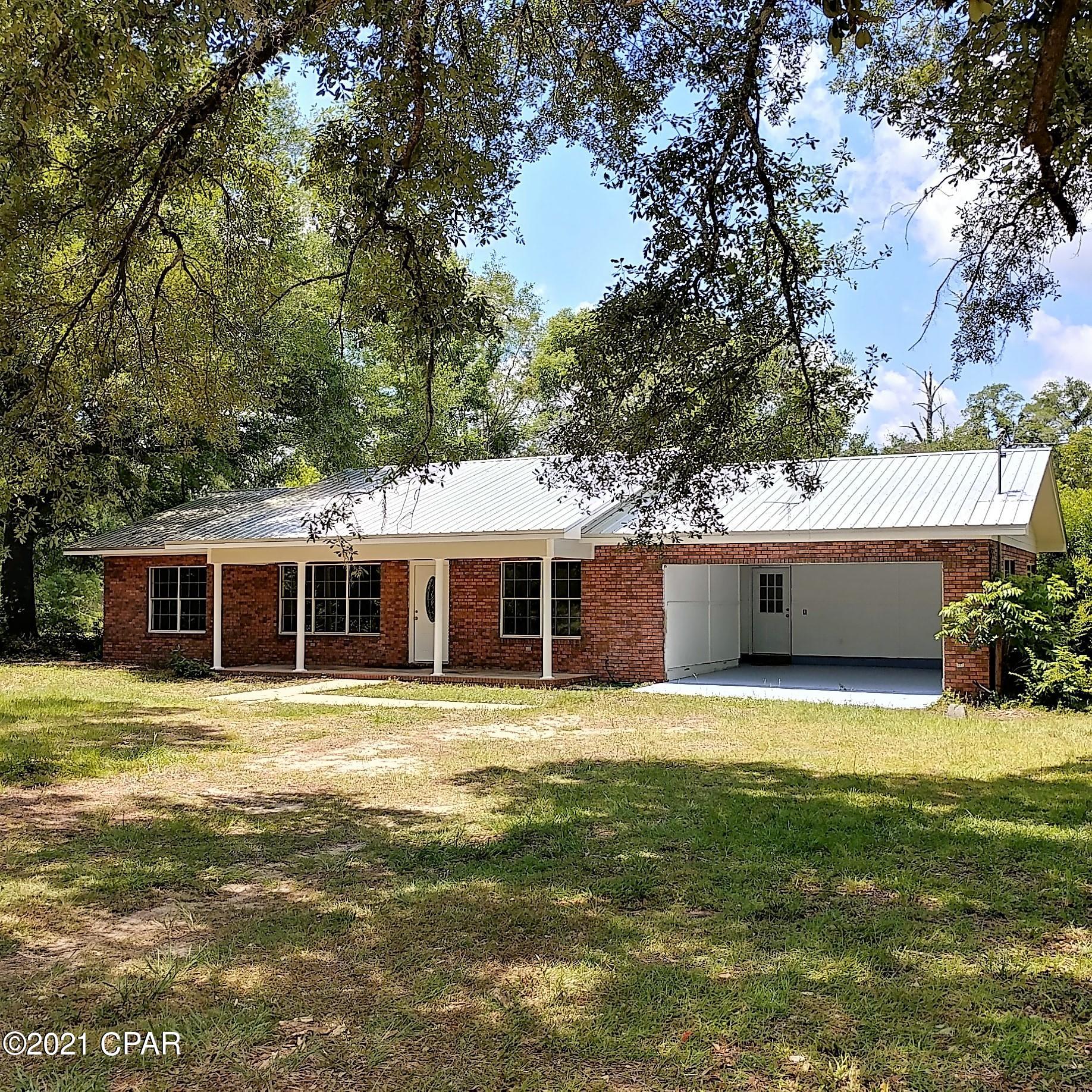 Nicely-renovated brick home within walking distance to Ponce de Leon Springs State Park.  Beautiful 3-Bedroom, 2-Bath home with a large living room, a nice kitchen with new countertops, a breakfast bar, and a separate dining area.  Master bedroom has 2 large walk-in closets and has it's own bath. All bedrooms have new carpeting. There is an amazing sunroom on the back of the house for your plants and office.  Big windows thruout the home. Has a covered front porch for your rocking chairs. Attached 2-car garage (door has been ordered but has not arrived yet). Located on a paved road and has city water and sewer. Seller is offering an allowance of $2500 toward purchase of appliances. Close to I-10, Vortex Springs, and Morrison Springs.  Only 1 hour to Panama City and South Walton Beaches.