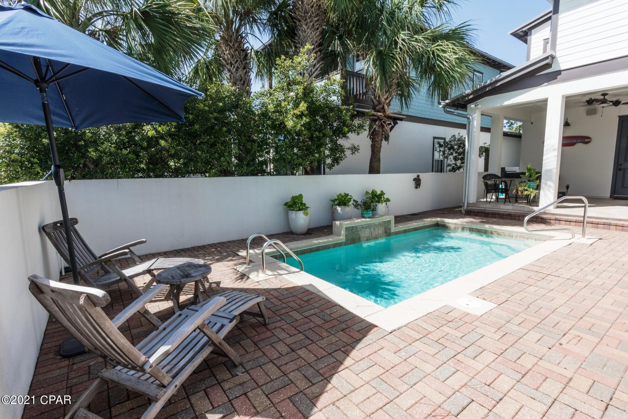 Beautiful custom-built two-story home on corner lot in Martinique!  This coastal craftsman inspired 4 bedroom 4 and a half bath home features and amazing back yard with private plunge pool with water feature, outdoor shower, and covered lanai.  Interior highlights include elegant open floorplan with 10' ceilings, crown molding and 18'' tile flooring throughout the first floor. 

The gourmet kitchen features solid oak cabinets, granite countertops, custom tiled backsplash, large pantry, and stainless-steel appliances, including a new gas stove.  A spacious open living room with a fireplace and a wall of windows adjoins the kitchen on one side and on the other a beautiful dining room with wainscoting details. The first-floor master suite has hardwood flooring and a spacious en suite bath which includes a walk-in shower, granite countertop vanity and a soaking tub. There is also a door which leads out to the pool and lanai area.  
The second-floor master suite has oak flooring, a private balcony and its adjacent bath includes double sinks in the granite vanity, a walk-in shower, whirlpool tub and "his-and-hers" walk-in closets. 
There are two other bedrooms upstairs, each with a bathroom.  The large upstairs lounging area features Brazilian Cherry hardwood floors and a large balcony overlooking the front yard.  
The two-car garage is accessed from the side of the home and features built in shelving and a door to access the pool area.  The home has a new upstairs complete HVAC system, and a new, extra-large water heater with a recirculating feature for instant hot water.  Recently re-sodded yard and repainted exterior of the house with high quality Sherwin Williams paint.  Windows are impact resistant and roof was inspected after Michael with no issues found.  
Martinique is a gated community with lots of natural landscaping, ponds, walking trails and a community pool. This prestigious neighborhood is nestled on the east end of Panama City Beach in the Grand Lagoon area.  This neighborhood is just 3 minutes from the Gulf of Mexico and the beautiful white beaches of the Emerald Coast and an easy walk to wonderful restaurants including Grand Marlin, J Michaels, and Captain Anderson's.  Take a stroll to the docks to watch the fishermen bringing in their catch or to the weekend farmer's market in front of Captain Anderson's.  Or enjoy the walking trails and local wildlife including deer, snowy egret, and wild heron and osprey.  

All information and sizes are approximate, and buyer should verify if important.