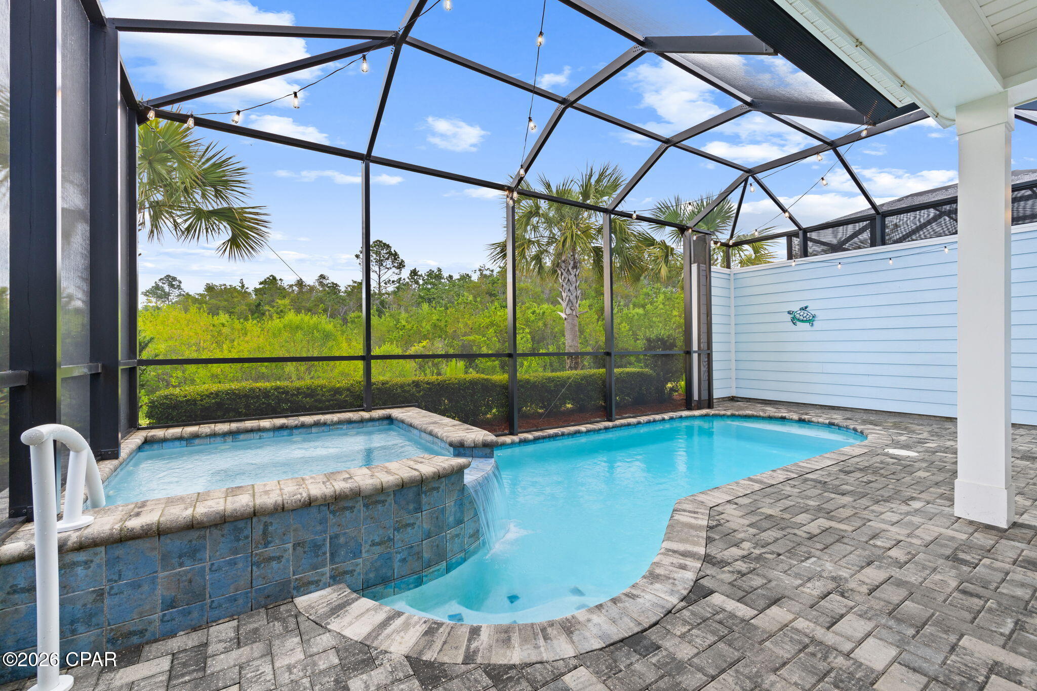 BARBUDA BAY! POOL!  HOT TUB!  LOCATION!  What more could you ask for?  Welcome to Margaritaville Watersound.  The Barbuda Bay is one the most desirable and sought after floor plans.  Ideally located just 3 minutes to the town square and its world class resort style amenities with convenient access to the mailboxes and the Barkaritaville Dog park.  This beautifully appointed Barbuda Bay villa blends coastal style with easy Florida living.  Inside you'll appreciate thoughtful upgrades such as plantation shutters, staggered six by thirty-six inch tile flooring throughout, crown molding, eight-foot doors, and five and a quarter inch baseboards. The kitchen shines with quartz countertops, a herringbone tile backsplash, forty-two inch cabinets, and a double oven.  Great for entertaining!  Ceiling fans and dimmer switches add comfort throughout as well.  Both bathrooms are finished with floor to ceiling tile and have granite countertops for a luxurious touch. The laundry room includes a utility sink and added extra cabinetry for even more storage.   New paint in several areas has just been completed. ALL the tile floors and baths throughout the villa as well as ALL the pavers front and back have been sealed. Step outside to your private oasis featuring a sparkling pool and relaxing hot tub. There is also a mister between the pool and lanai. All under an extended lanai with pavers.  The pool can be heated during the cooler months for your year round water filtration system and a garage with insulated walls and epoxy flooring.  Driveway pavers is yet another upgrade adding even more value to the villa.  All tile on the The HOA covers lawn care, exterior painting, and roof replacement as needed providing low maintenance living so you can truly enjoy a carefree lifestyle.  This vibrant 55 plus community offers endless activities so there's always something to enjoy.  The amenities include a state-of-the art fitness center with indoor lap pool and hot tub, resort style pool with zero entry, pickle ball, bocce ball, tennis, basketball, walking trails, dog park, the popular Bar & Chill restaurant overlooking the Intracoastal waterway, as well as a full calendar of clubs, concerts, and social events.  Don't forget the kayak launch.  Perfect for exploring the waterway.  The town center has a ceramic shop, theater, meeting rooms, wood working shop, and there is an events calendar constantly adding new events for your entertainment.  Live music daily by the pool and at the Town Square on the weekends.  Completion date for the new Publix grocery store is '27.  A future marina will be just off Latitude Blvd.  The newly opened medical center is 3 miles away with a planned hospital to open 2027.  Located just 7 miles from the Gulf Coast's world famous sugar white beaches, Margaritaville Watersound has it all!  Discover why this beautiful Barbuda Bay villa is the perfect place to call home.