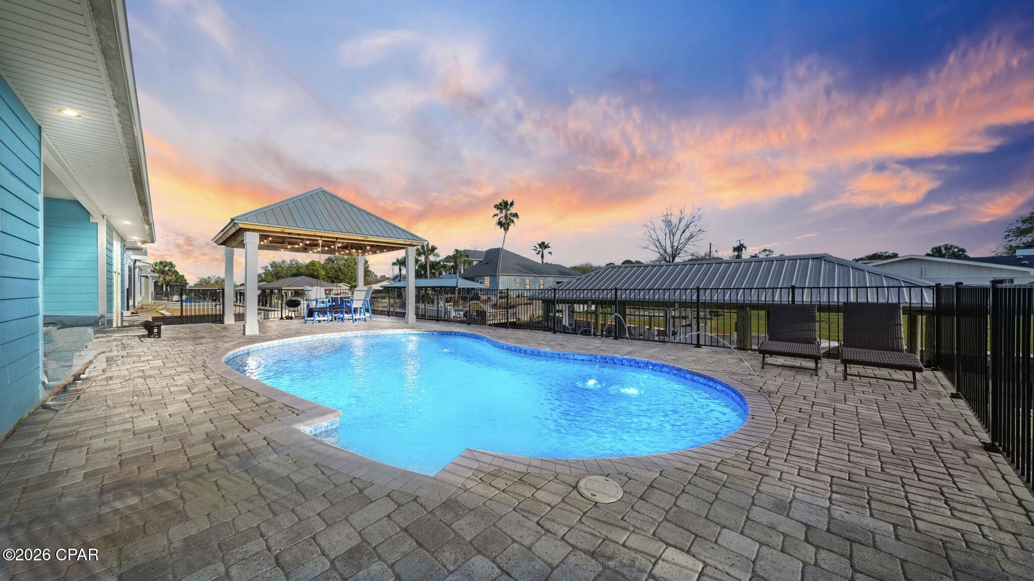Under contract accepting backup offers

Fully furnished, 
Indoor and outdoor furniture, plus the hot tub included!!
Your Private Dock Awaits.
Ultimate Boating Paradise in Gated Dolphin Bay! 
Imagine stepping out your back door to direct canal access on St. Andrews Bay with your own private dock and boat lift--ready for endless days of fishing, cruising, and Gulf adventures! This jaw-dropping 5-bedroom, 3-bath, ~2,775 sq ft contemporary stunner (built 2019) delivers coastal luxury at its finest: soaring open-concept living spaces, premium high-end finishes, and a show-stopping dedicated home theater perfect for epic movie nights or game-day blowouts.
Nestled in the heart of Panama City Beach's hottest gated community, you're minutes from sugar-white Gulf beaches, world-class dining, shopping, and endless entertainment. Whether it's your forever dream home, a sought-after vacation escape, or a high-potential investment property, this rare gem screams ''Florida coastal living done right.'' Don't wait--opportunities like this vanish fast! Schedule your private tour today and make it yours.