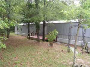 4.17 Acres with immaculate mobile home. 3 bed/2 bath single wide. Home is furnished and in very good condition. Ready to move in. Land is wooded for privacy. Beautiful area. Must see. Located near the Seacrest Wolf Preserve.