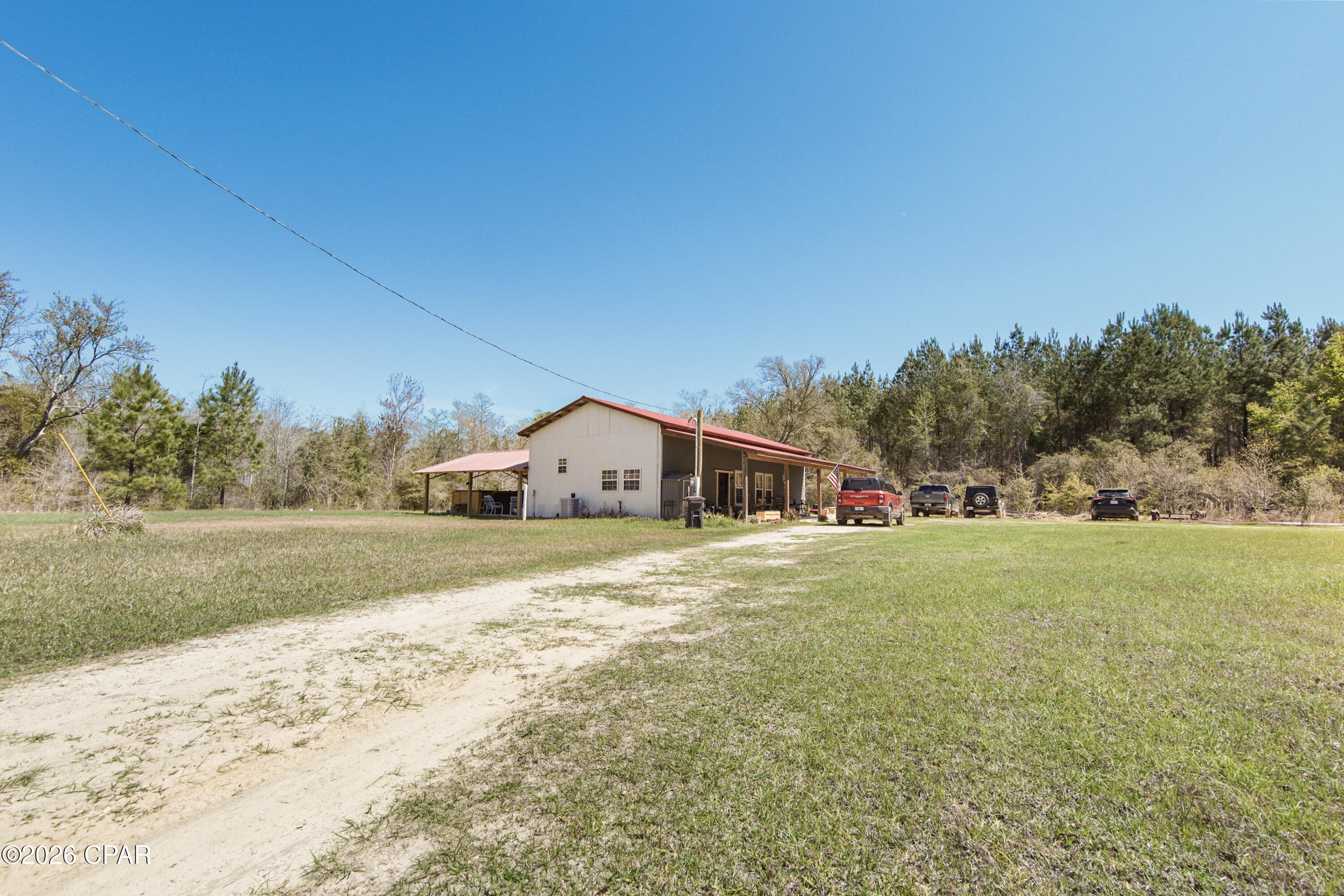 The Modern Homestead: With More Character than a John Wayne Marathon! 
We're burning daylight over here! Tucked away just outside of Bonifay, this 21.51-acre estate is the ultimate ''getaway'' that you never have to leave.  If you've been looking for the ultimate escape where modern integrity meets old-world soul, this is your destination. 
The Barndominium: Where Grit Meets Glamour.
Forget what you know about ''rustic.'' Built in 2022, this custom barndominium blends the structural integrity of a modern build with the soul of a vintage farmhouse.
Adorned with a vintage, artisan interiors -  Stepping inside is like walking into a magazine. Adorable, warm, and rich with reclaimed materials that tell a story.
A massive, open-concept living space welcomes you home - designed for entertaining or unwinding after a day in the woods.  The master suite features a walk-in closet so large it's practically its own zip code. (This space could be a ''blank canvas'' and easily converted into a bunk room or home office).
Both the kitchen and bath are perfectly appointed with ''rustic-chic'' finishes that prove you don't have to sacrifice style for the country life.
21 Acres of Opportunity! 
Comes with it's own privacy screen! The front of the over 21 acres features a lush, natural wetland buffer providing an organic area that shields the homestead from the road. Once you pass through, you enter a high and dry paradise shaded by massive, mature trees. It's quiet, it's secluded, and it's yours.
Relax on more than one level! Unwind in your private swim spa--the perfect way to cool off after a morning of land management or hunting. The ultimate year-round luxury for fitness and relaxation.  Worth mentioning - Includes a pole barn and multiple sheds. Whether you have tractors, ATVs, or a woodshop hobby, there's a place for it.
This is the ultimate ''set-and-forget'' property. Use it as your primary residence and breathe the fresh air or keep it as the world's most sophisticated hunting lodge. With 21+ acres, there is limitless room to expand.
The sellers are ready to pass the torch! Properties with this much acreage and a 2022 build do not last in this price bracket. 
''I'm looking for a place where a man can breathe'' John Wayne. Giddy up, John. This is that.
