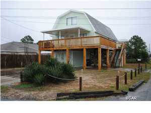 Great location for this beach home up on stilts just a couple of blocks to the Gulf of Mexico and public boat ramp on the Grand Lagoon. This home is in great condition and ready for its new owner. Very pretty corner lot with a large workshop under the home. There are 3 large bedrooms and 2 full bathrooms. The living areas plus huge master bedroom and bath are on the second floor with the two additional bedrooms and a full bath, on the third floor. If you are looking for a great deal at the beach, this is it!!