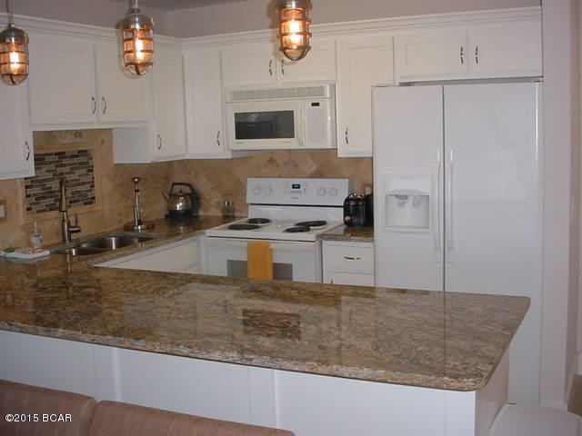 Ground floor unit newly remodeled with granite counter tops in kitchen, and bathroom/dressing area, accent lighting above and below kitchen cabinets, tile flooring throughout the unit and a large deck facing the marina where you can sit and watch the boats, and enjoy the evening sunsets. Bay Point offers 2 golf courses, 24-hr roving security, tennis, and boating.Bay Point Community association fee $1325/year.Measurements are approximate, if important please verify. Listing agent is related to seller.