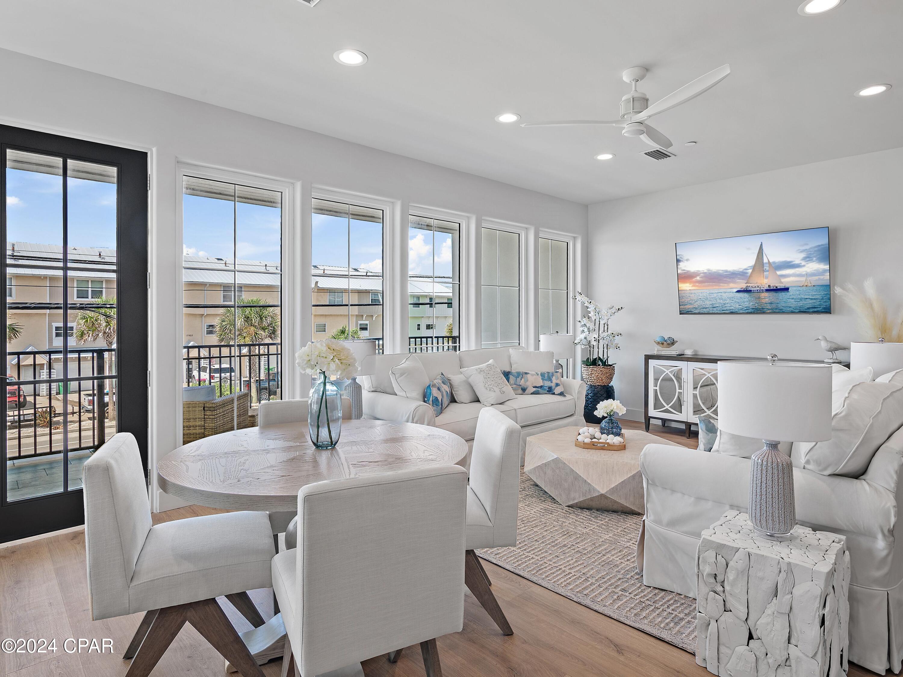 Experience elevated coastal living in this brand-new, fully furnished 4-bedroom, 4.5-bathroom townhome spanning 2,469 square feet, located directly across from the beach in the heart of Laguna Beach on Panama City Beach's serene west end.

Every detail of this residence has been curated for luxurious comfort and refined coastal style. Each unit has been fully outfitted with local designer finishes, blending texture, tone, and quality craftsmanship to create a truly turn-key experience — whether you're seeking a personal retreat or a high-performing rental investment.

Wake up to sweeping gulf views from your primary suite, complete with its own private balcony — ideal for morning coffee or evening sunsets. The thoughtful layout also includes a second primary suite, a spacious king bedroom, and a custom built-in bunk room to accommodate guests in style and comfort.

Inside, enjoy an airy, open-concept living space that flows onto a tiled balcony framed by natural V-groove ceilings. Premium features include GE Monogram appliances, gas cooktop, solid core doors, private elevator, and ensuite bathrooms for all bedrooms. The home is constructed with concrete and wood, with reinforced rebar-filled, 8'' concrete separation walls for added soundproofing and structural integrity.

Additional highlights include a two-car garage, two-car carport, and access to a community pool shared by only five townhomes.

Built to exceed expectations, the home incorporates advanced systems like Gold Bond waterproof sheathing, Schluter bathroom waterproofing, concrete band headers, and an individual fire suppression system — combining peace of mind with enduring value.

Unmatched Location & Lifestyle: Perfectly positioned just a short stroll to Thomas Donuts and Carousel Grocery, this west-end gem is also less than 3 miles from Pier Park — Panama City Beach's premier shopping, dining, and entertainment hub. Explore over 120 stores, Grand IMAX Theatre, Dave & Buster's, and SkyWheel, with exciting new attractions like Topgolf and Dolly Parton's Pirates Voyage Dinner & Show on the horizon.

And when you're ready for more upscale coastal charm, the famed beach towns of 30A are just 15 minutes away, offering boutique shopping, award-winning dining, and timeless Florida beauty.

This is more than a home — it's a lifestyle defined by design, comfort, and convenience. Schedule your private tour today and step into a fully realized beachside retreat.