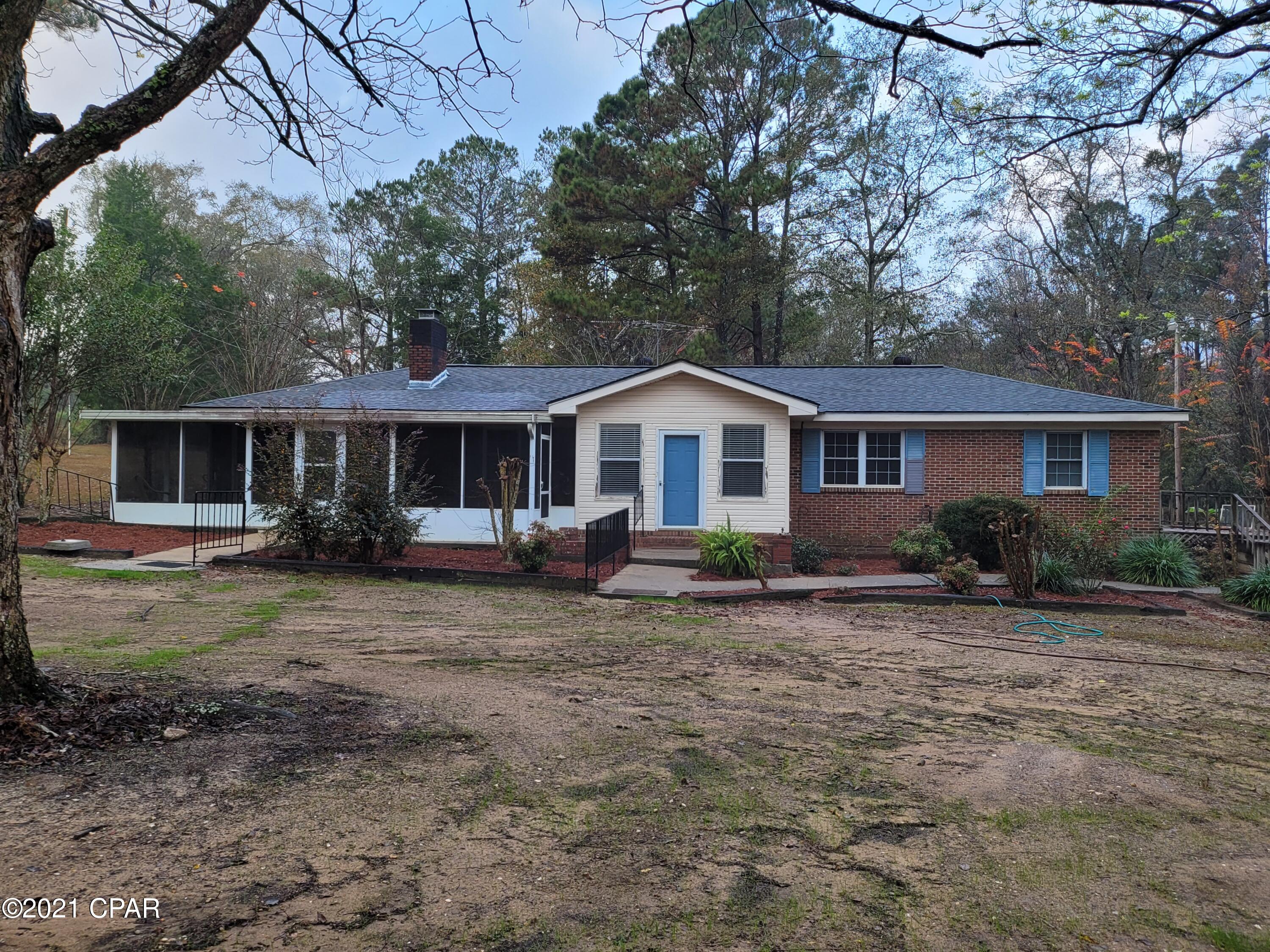 CURRENTLY UNDER CONTRACT, SELLER ACCEPTING BACKUP OFFERS. So much space with this 3/2 brick home in Graceville. Home offers a foyer and an open kitchen, dining, and living areas. Living room has gas fireplace. Family room for extra space. Master bedroom has full bath and a bonus room to make a 3rd bedroom (was used as a sewing room) or an office. Full bath in hall has tiled shower. Screened in patio area for additional entertaining or sitting outside and enjoy the peace and quiet. Wooden deck along north side of the home with access from bonus room. Nice country setting. Not far off of Hwy 77 for local amenities and within several miles from other small town businesses. With some TLC this would make a great home.
